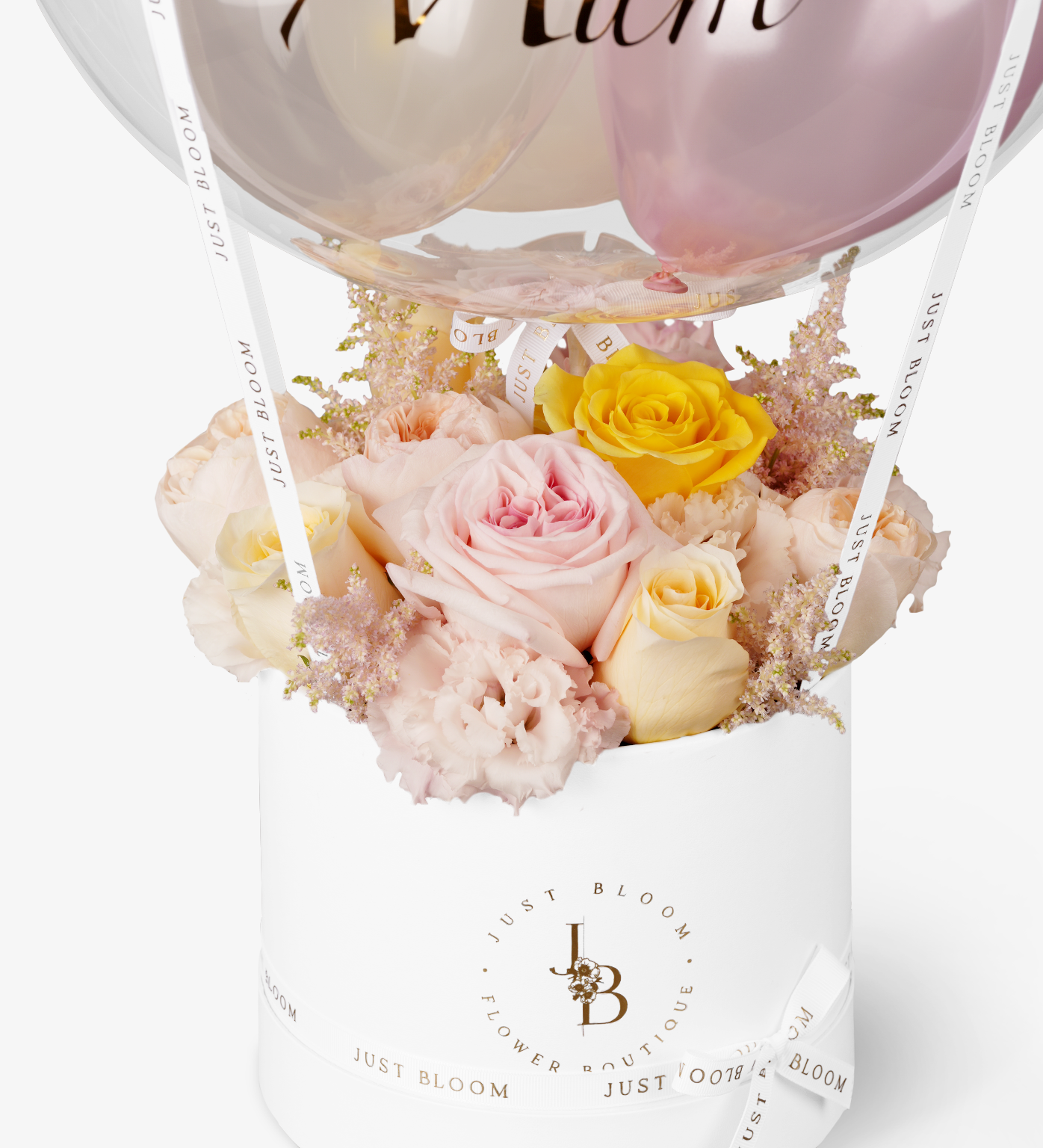 Detailed view of pastel rose arrangement in white Just Bloom round box