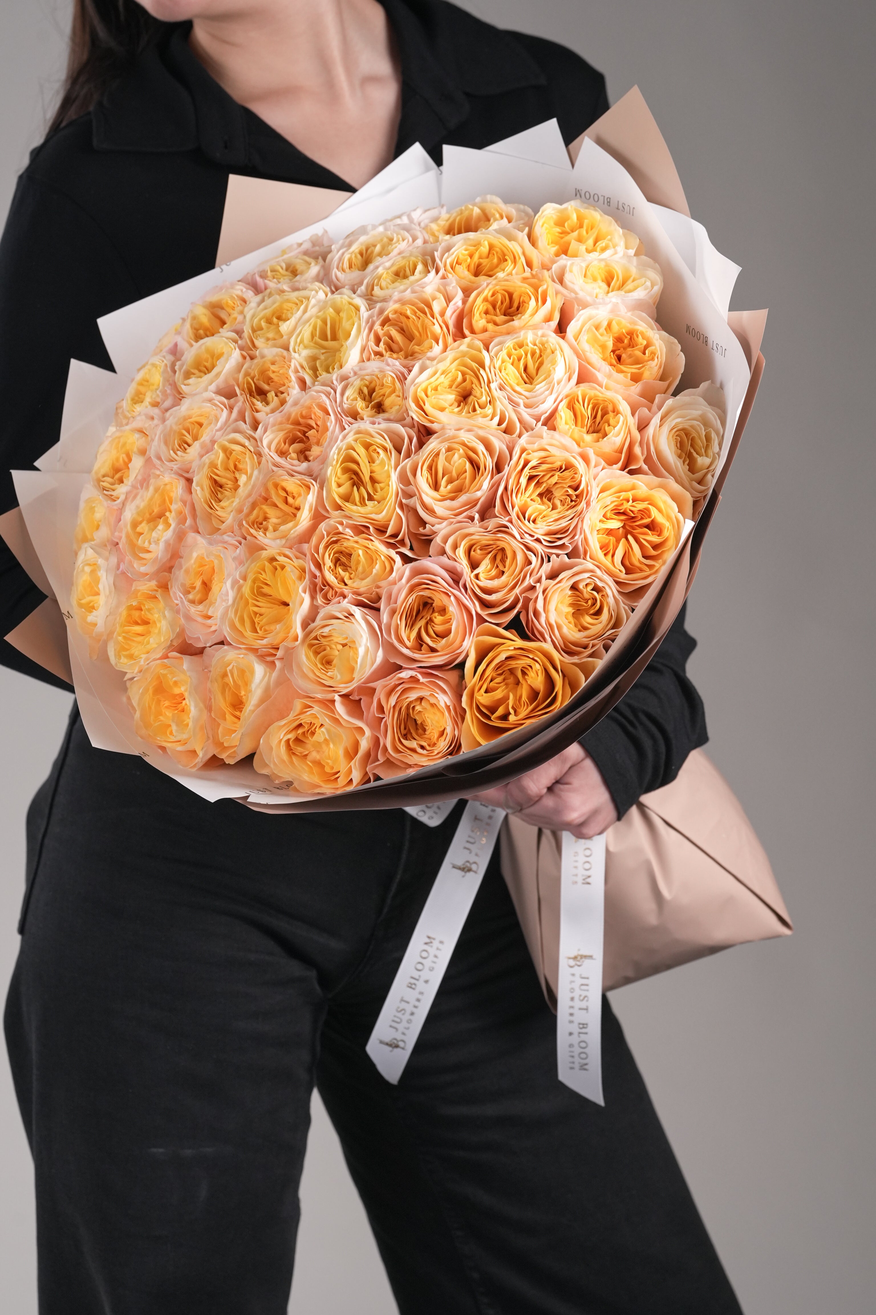 Close-up of Genesis bouquet featuring premium Ecuadorian champagne garden roses in soft gradient tones