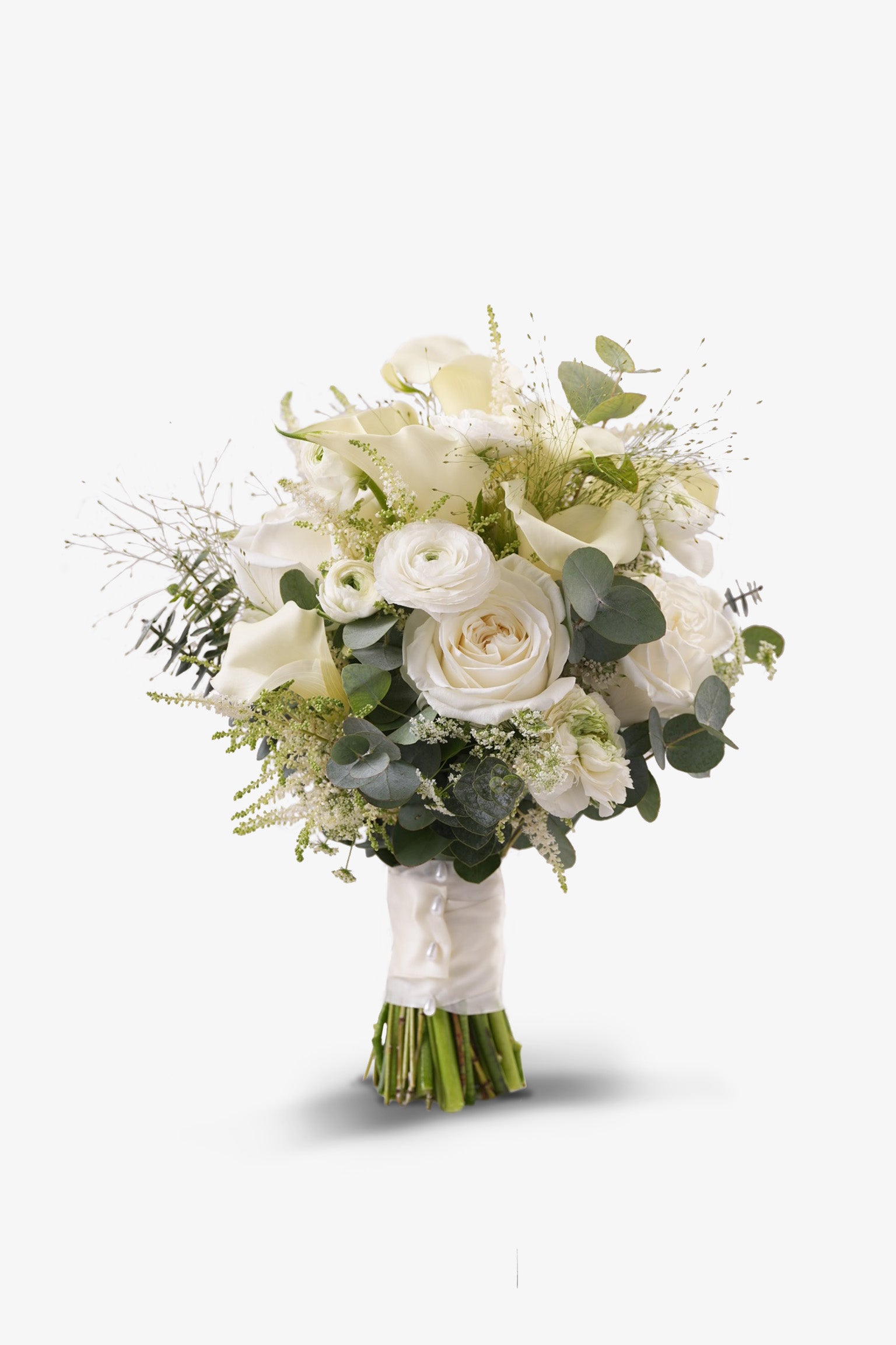 Elegant white bridal bouquet with ranunculus, roses, and calla lilies – styled with satin ribbon