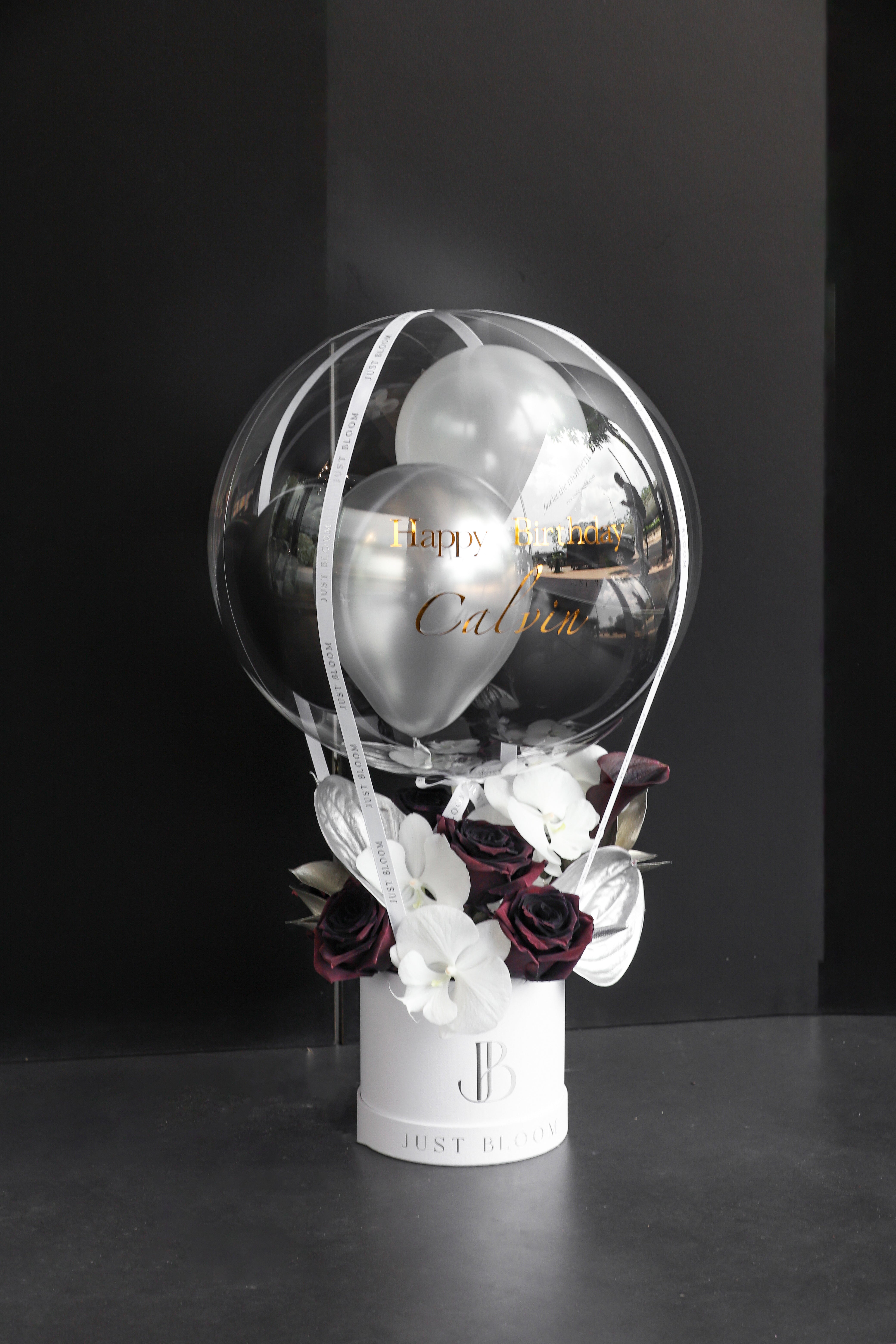 Dramatic flower box with deep burgundy roses, white orchids, and silver Anthuriums in a white Just Bloom round box against a dark background — Just Bloom Hong Kong