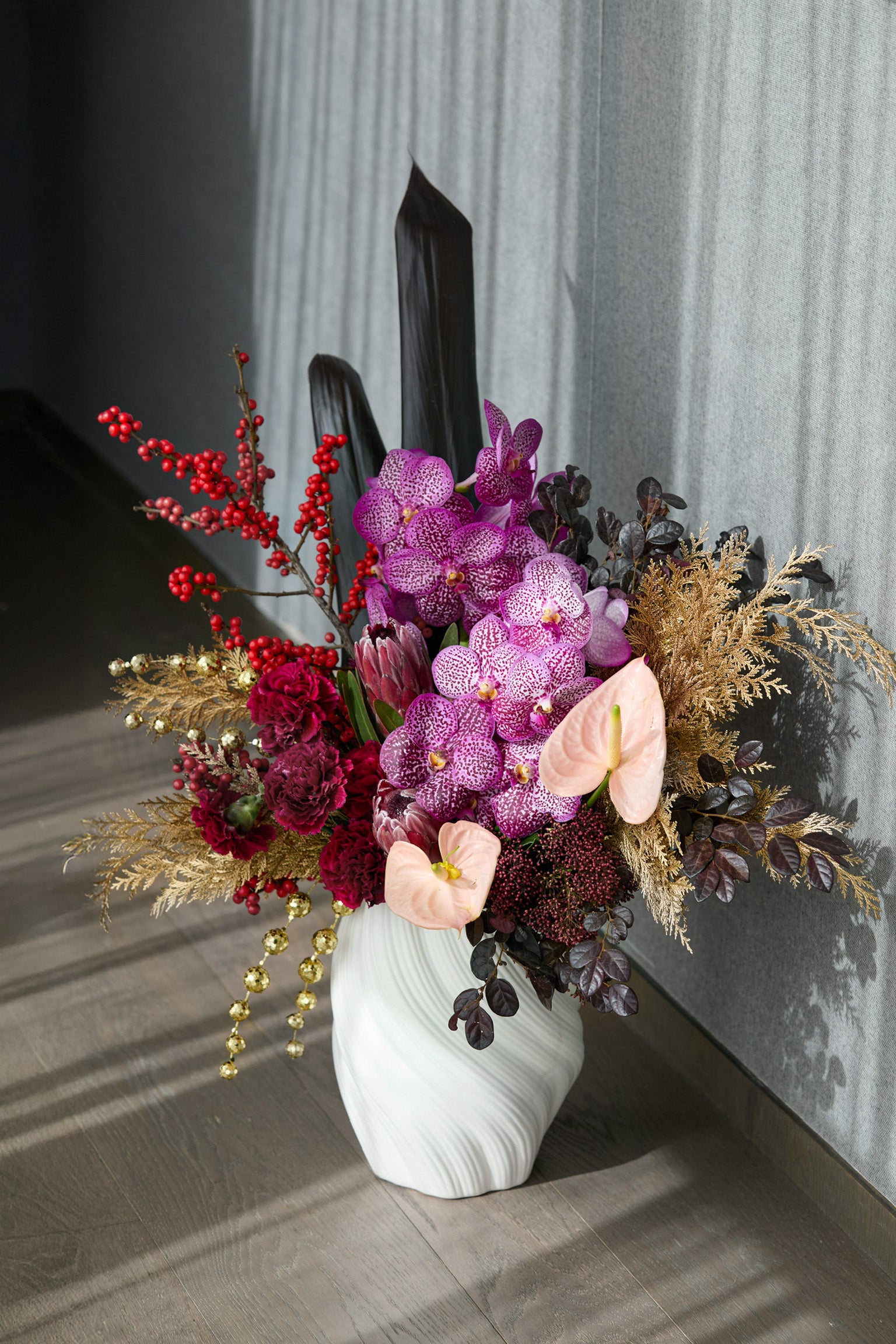 Imperial Ascent CNY floral arrangement featuring speckled purple orchids gold botanicals and black foliage Just Bloom Hong Kong