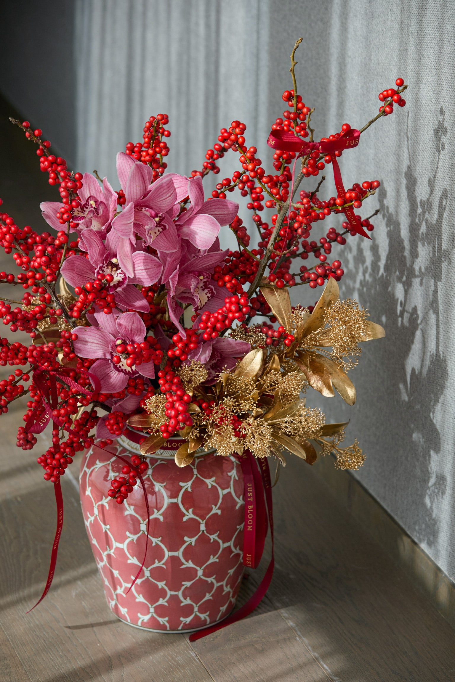 Premium pink cymbidium orchid arrangement with crimson berries gold preserved florals luxury CNY flowers Just Bloom