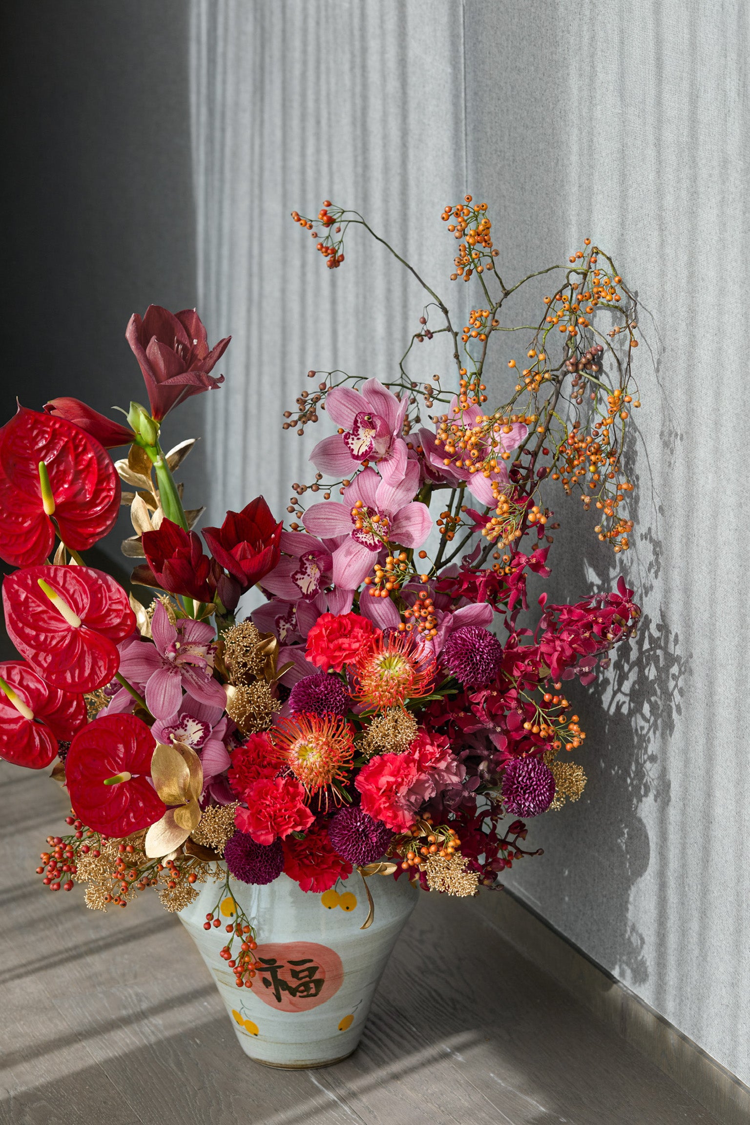 Year of the Horse opulent floral statement featuring red anthuriums orange berries pink orchids gold accents Chinese New Year Hong Kong
