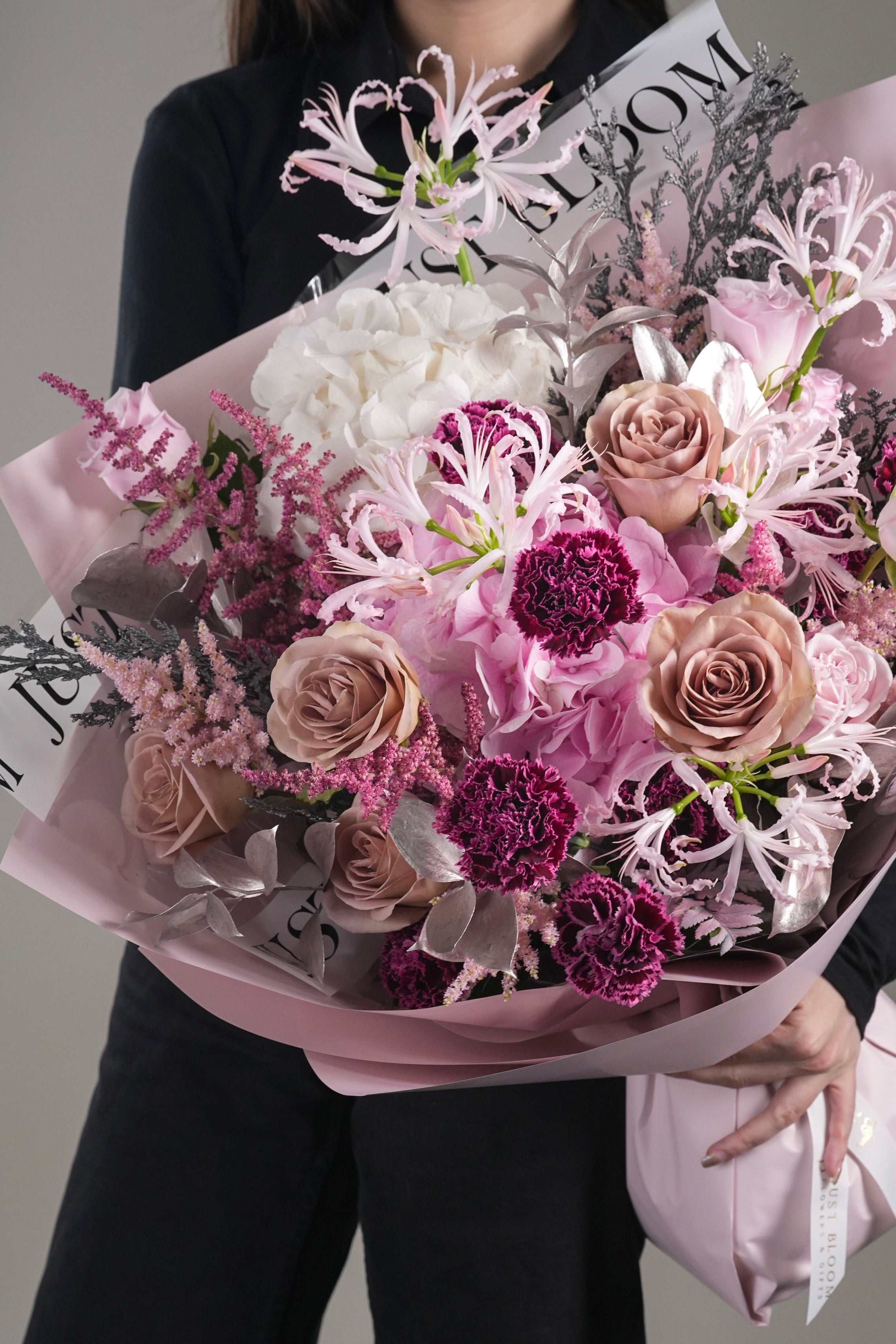 Girl holding Adriana hand-tied bouquet in mauve and pink tones - Just Bloom HK