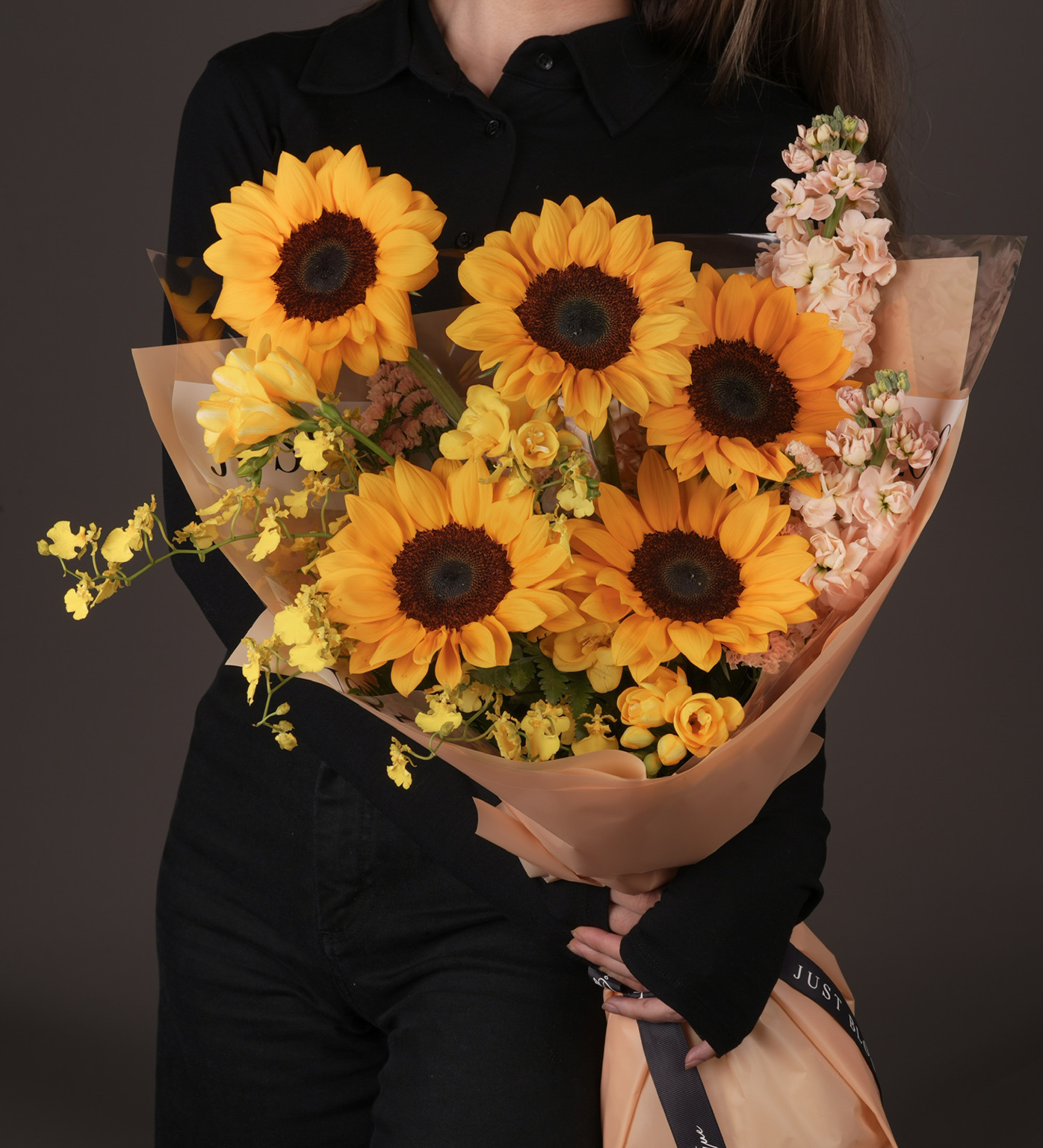 Girl holding Aisha small yellow floral bouquet with sunflowers - Just Bloom HK