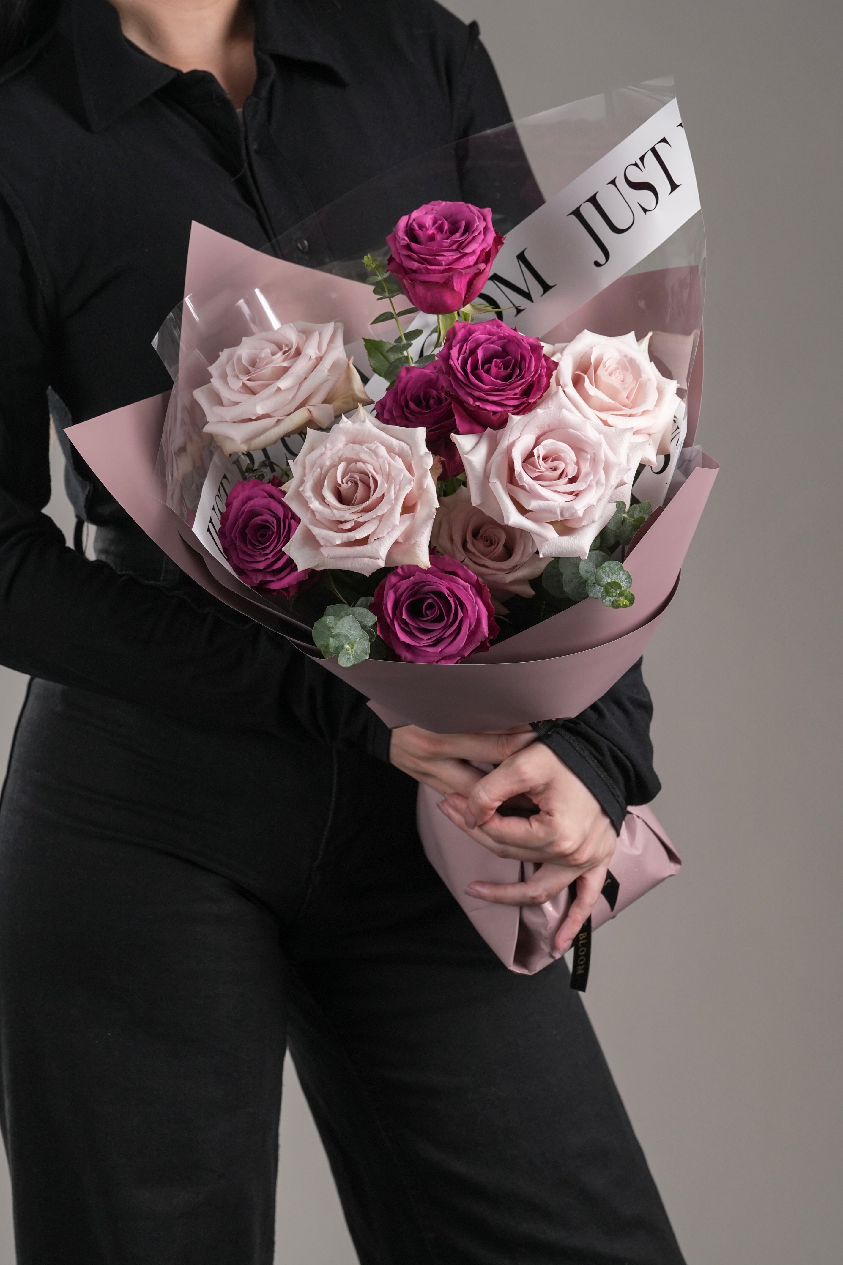 Side view of Asa bouquet – showing vibrant purple and quicksand roses in elegant wrapping.