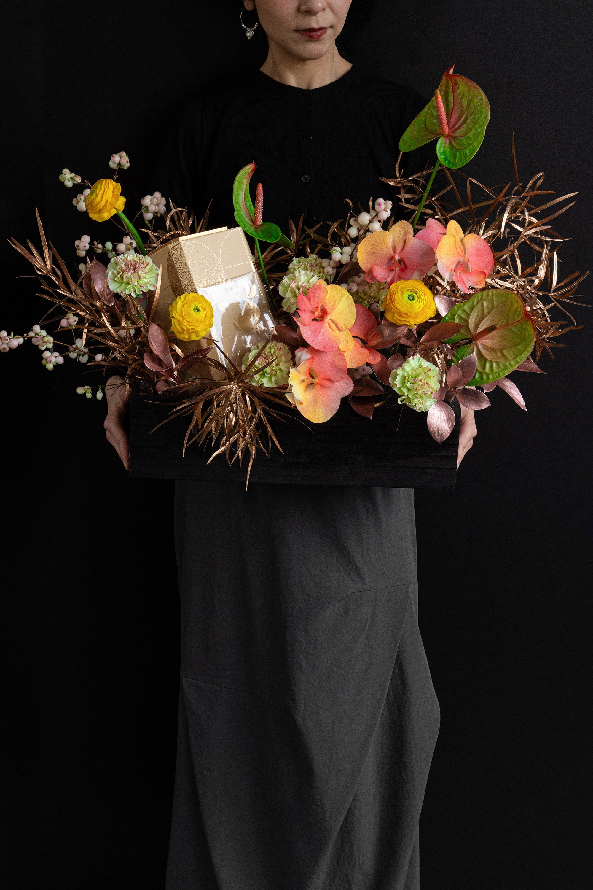 Model holding Just Bloom Autumn Reflection flower box with golden yellow and coral florals and chocolate gift box — Just Bloom Hong Kong