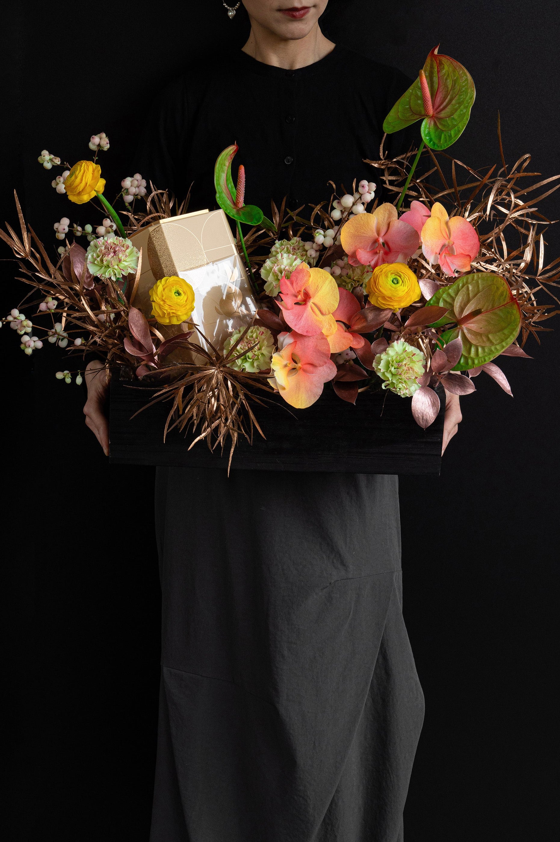 Model holding Just Bloom Autumn Reflection flower box with golden yellow and coral florals and chocolate gift box — Just Bloom Hong Kong