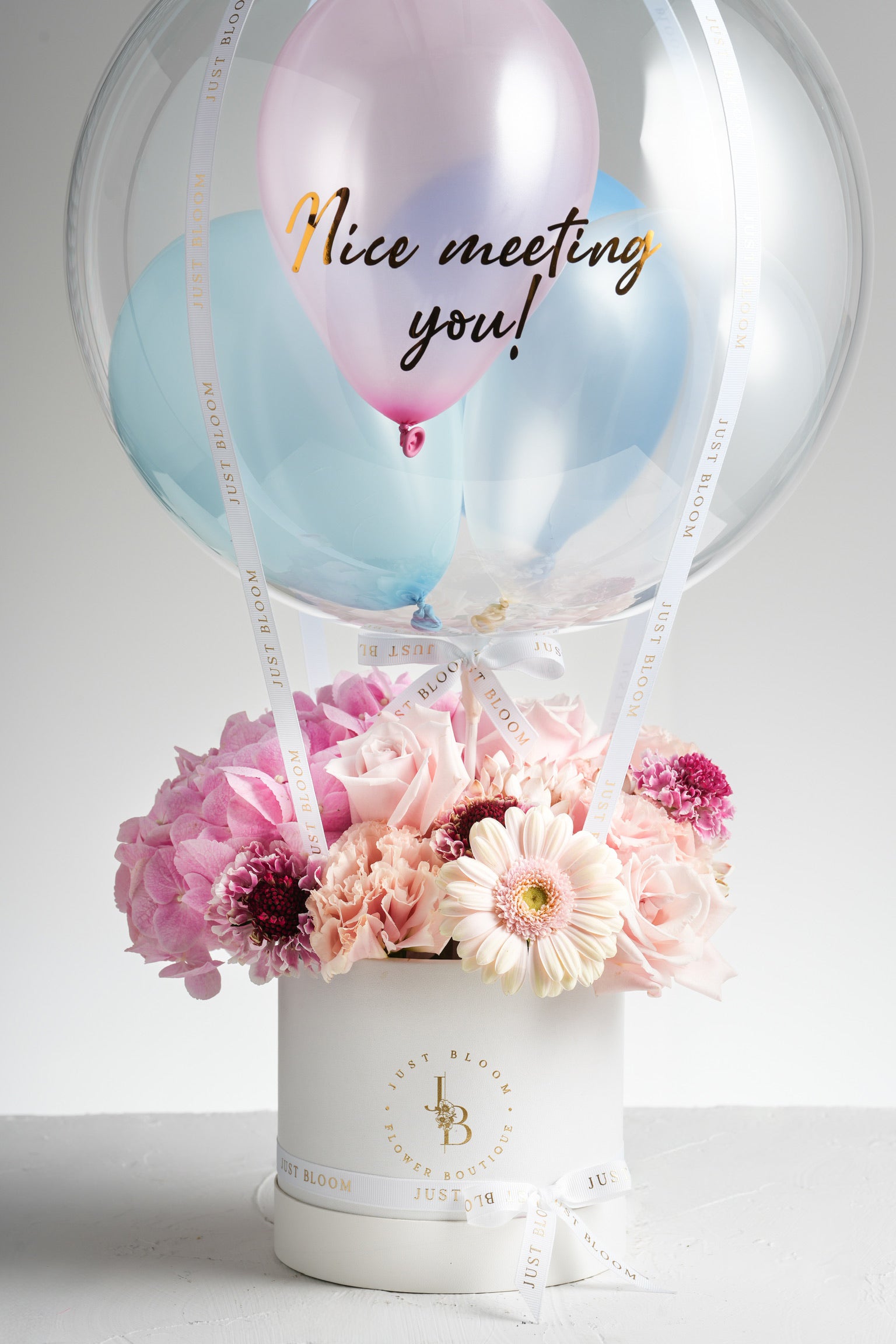 Blaire - A soft pink floral arrangement featuring Ecuadorian roses, hydrangeas, gerberas, carnations, and Dutch chrysanthemums, designed to radiate warmth and joy. Available for same-day delivery in Hong Kong by Just Bloom.