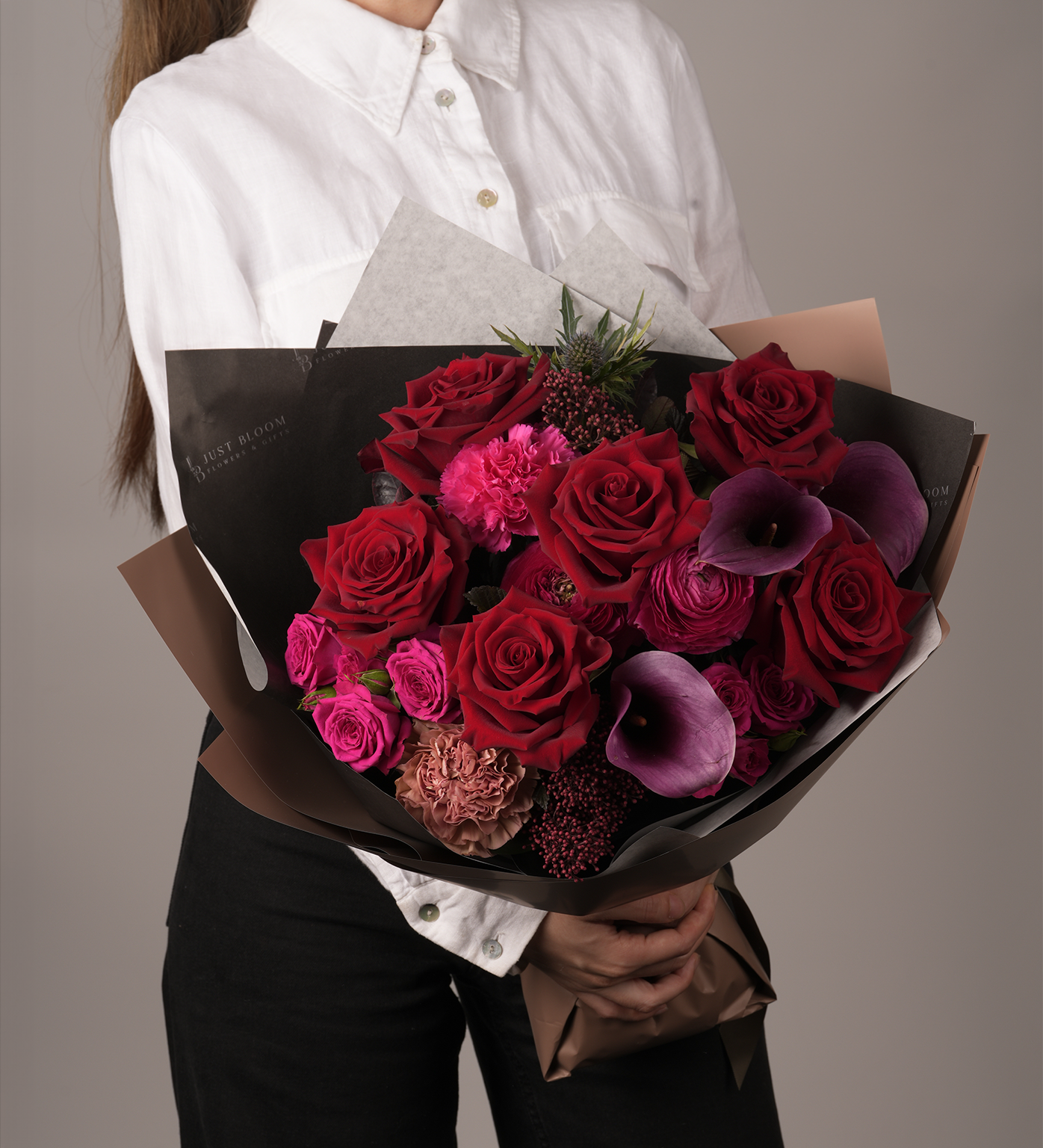 Side view of Cameron Bouquet with bold mix of red, pink and purple flowers