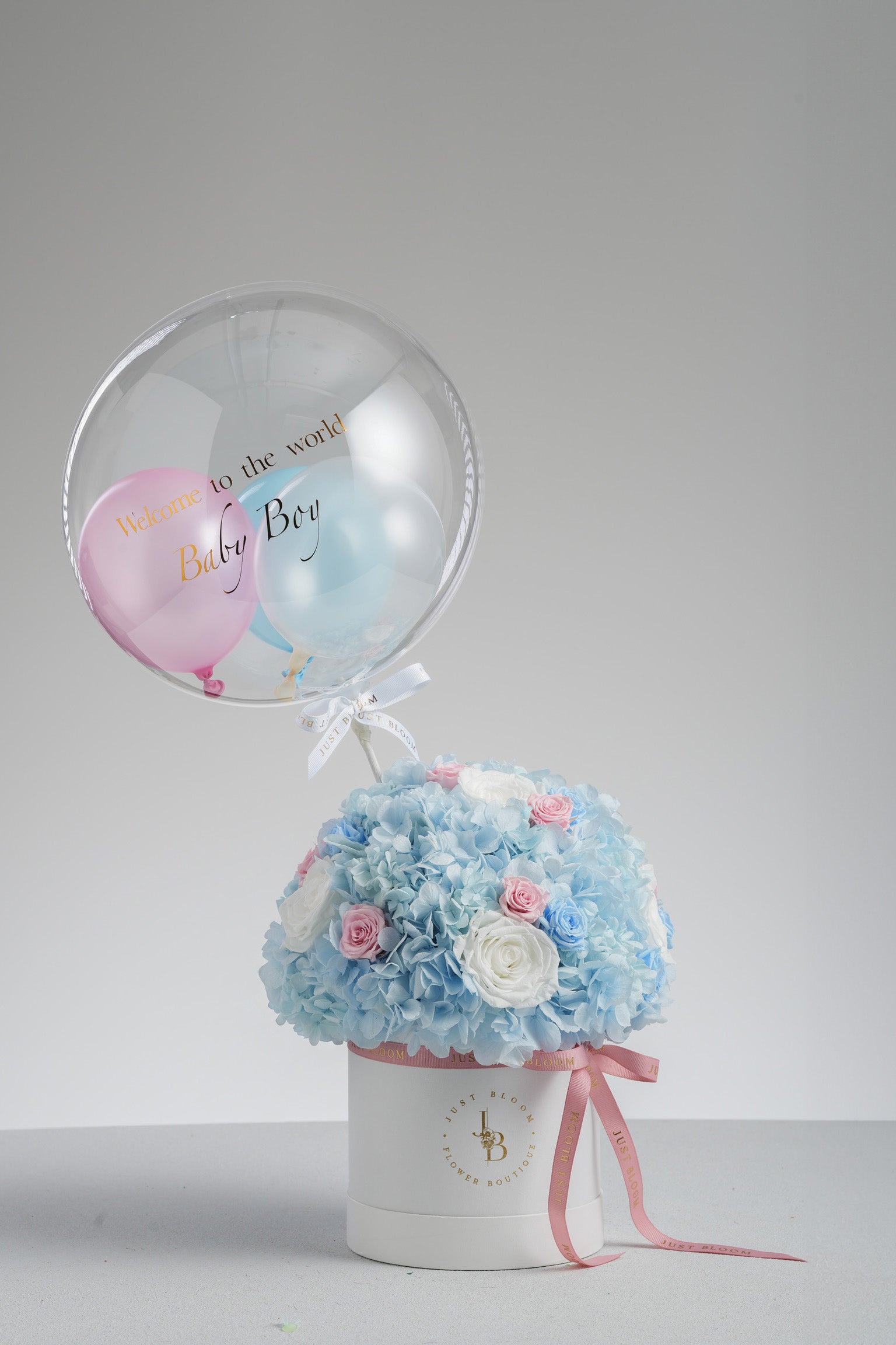 Just Bloom Hong Kong Capri preserved flower box – front view showing soft blue and pink tones in a white hatbox