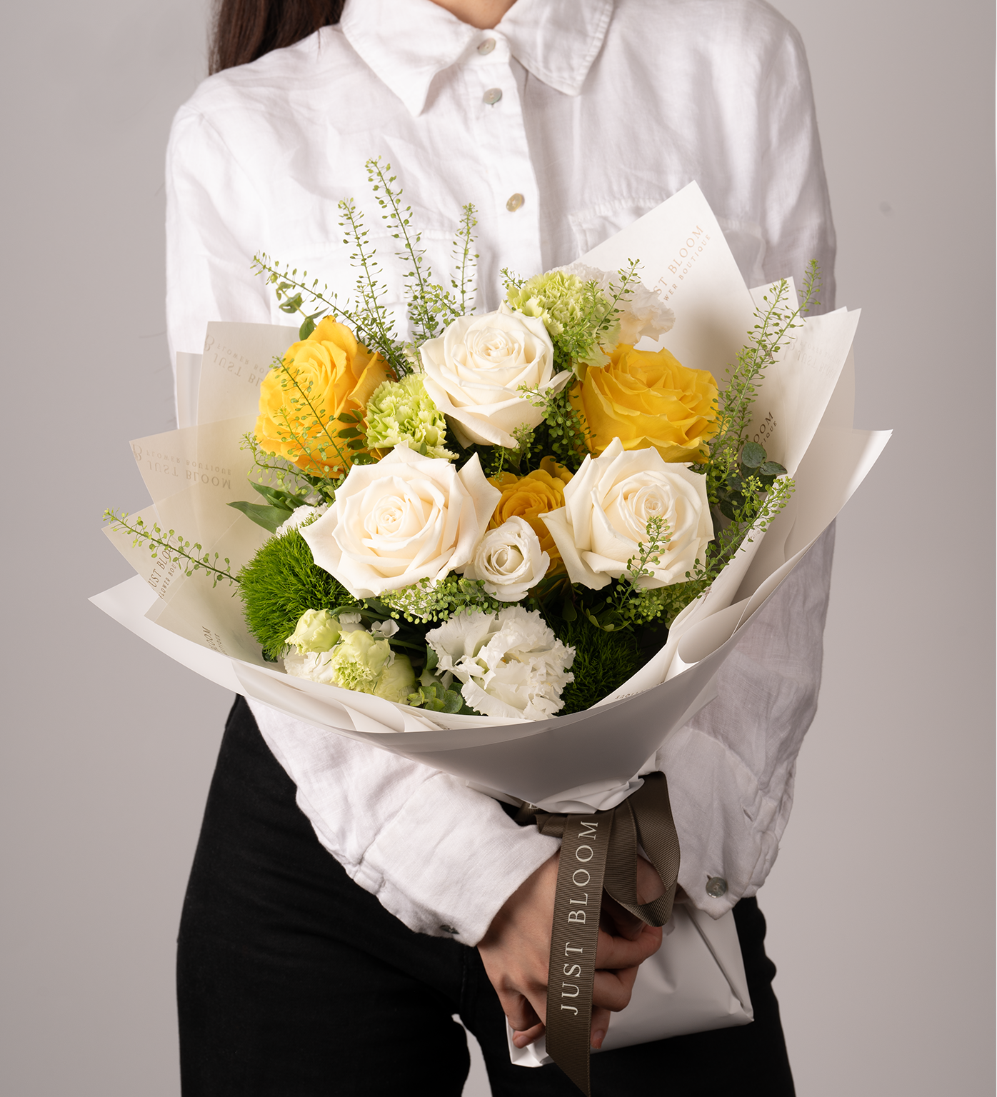 Ryan bouquet with yellow and white roses and eucalyptus foliage