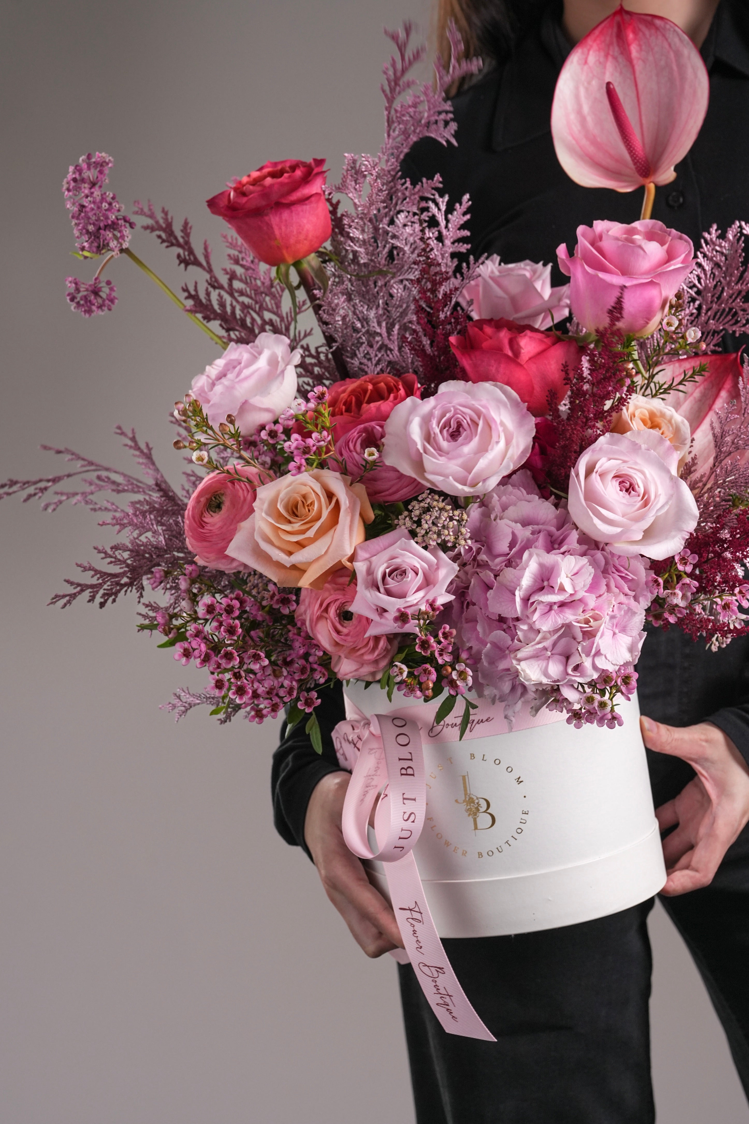 Close-up view of Coraline flower arrangement showing roses and dyed leaves