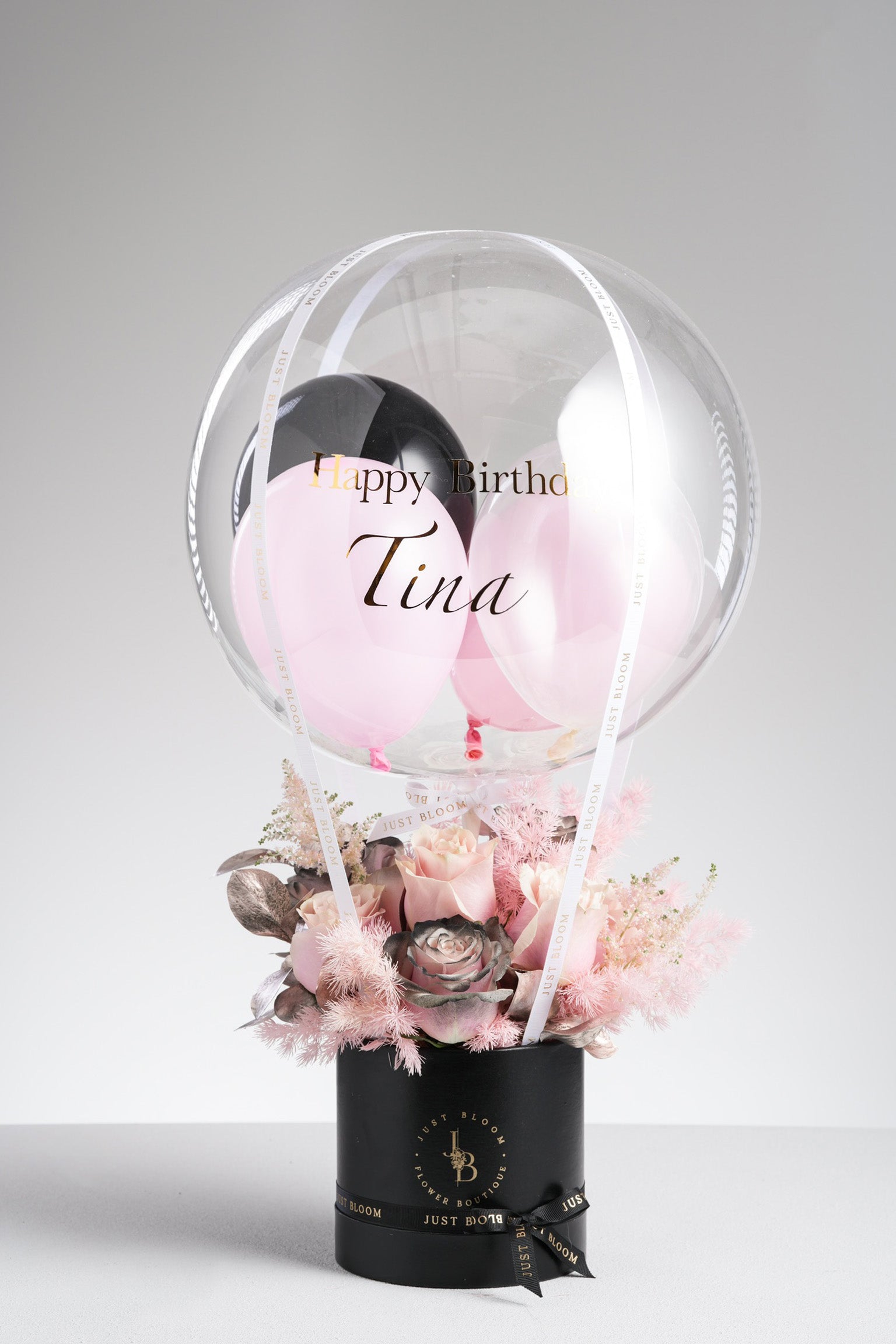 Dayana - A modern floral arrangement featuring pink roses, black-sprayed rose, pink astilbe, baby’s breath, and rose gold foliage. Designed for edgy elegance and available for same-day delivery in Hong Kong by Just Bloom.