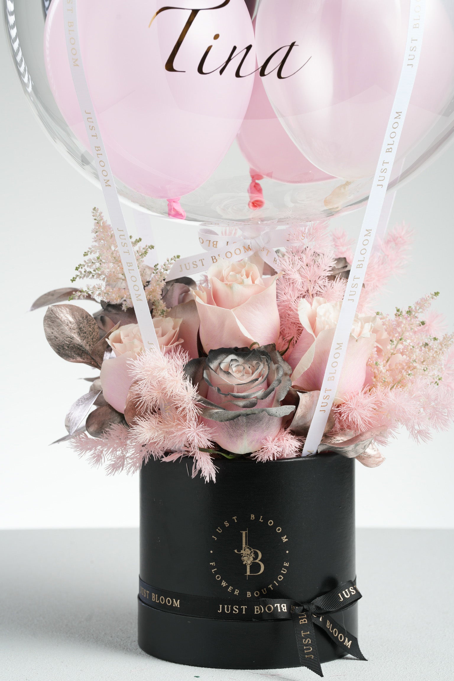 Dayana - A modern floral arrangement featuring pink roses, black-sprayed rose, pink astilbe, baby’s breath, and rose gold foliage. Designed for edgy elegance and available for same-day delivery in Hong Kong by Just Bloom.