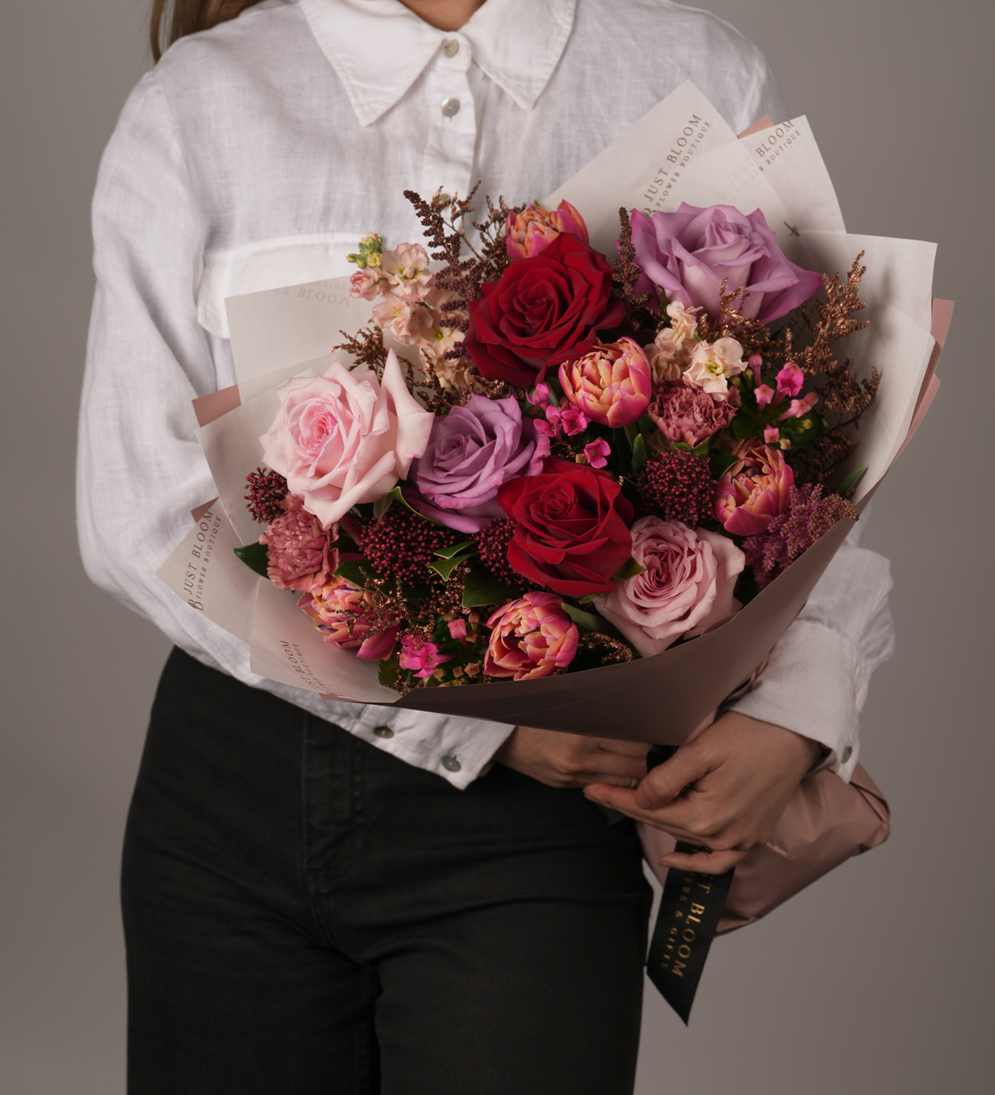 Romantic Dylan flower bouquet held in front of white shirt – side angle close-up