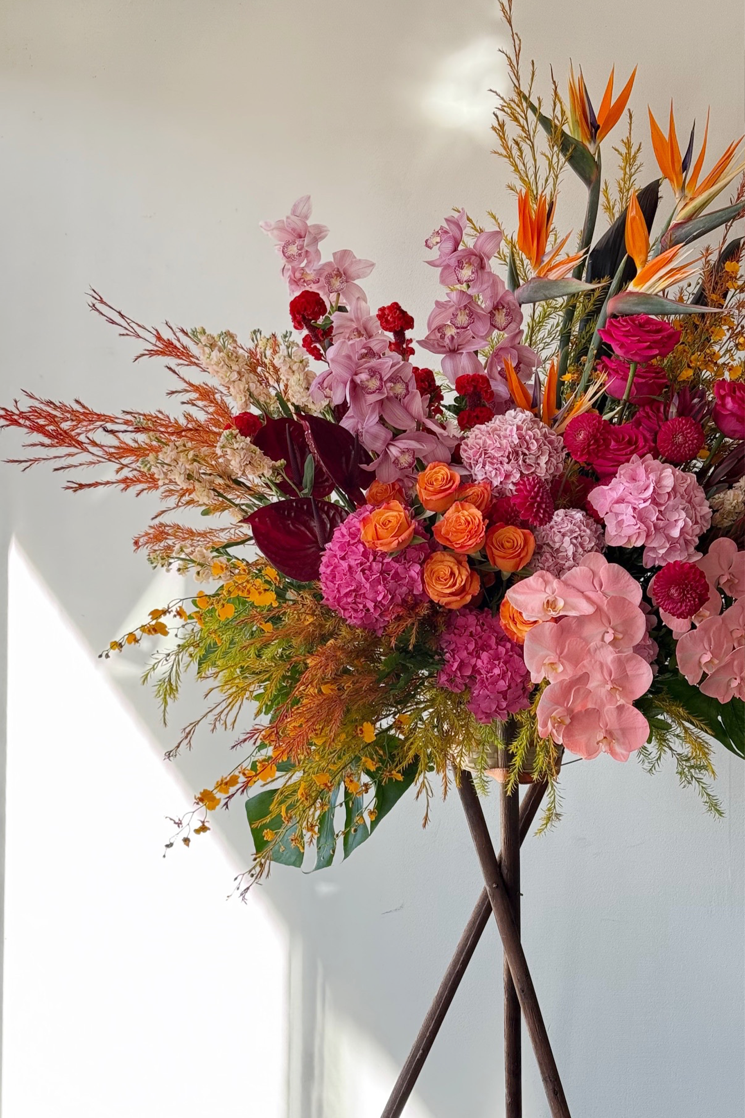 Euphoria luxury grand opening flower stand with hydrangeas, roses, phalaenopsis orchids, and exotic tropical flowers in dramatic colours