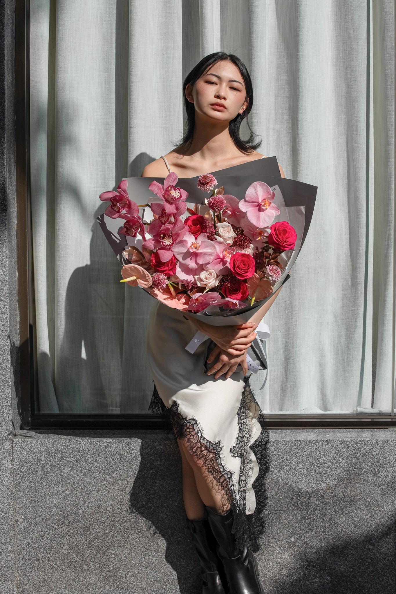 Fierce Love fresh flower bouquet with pink orchids burgundy roses and dramatic textures for Valentine's Day