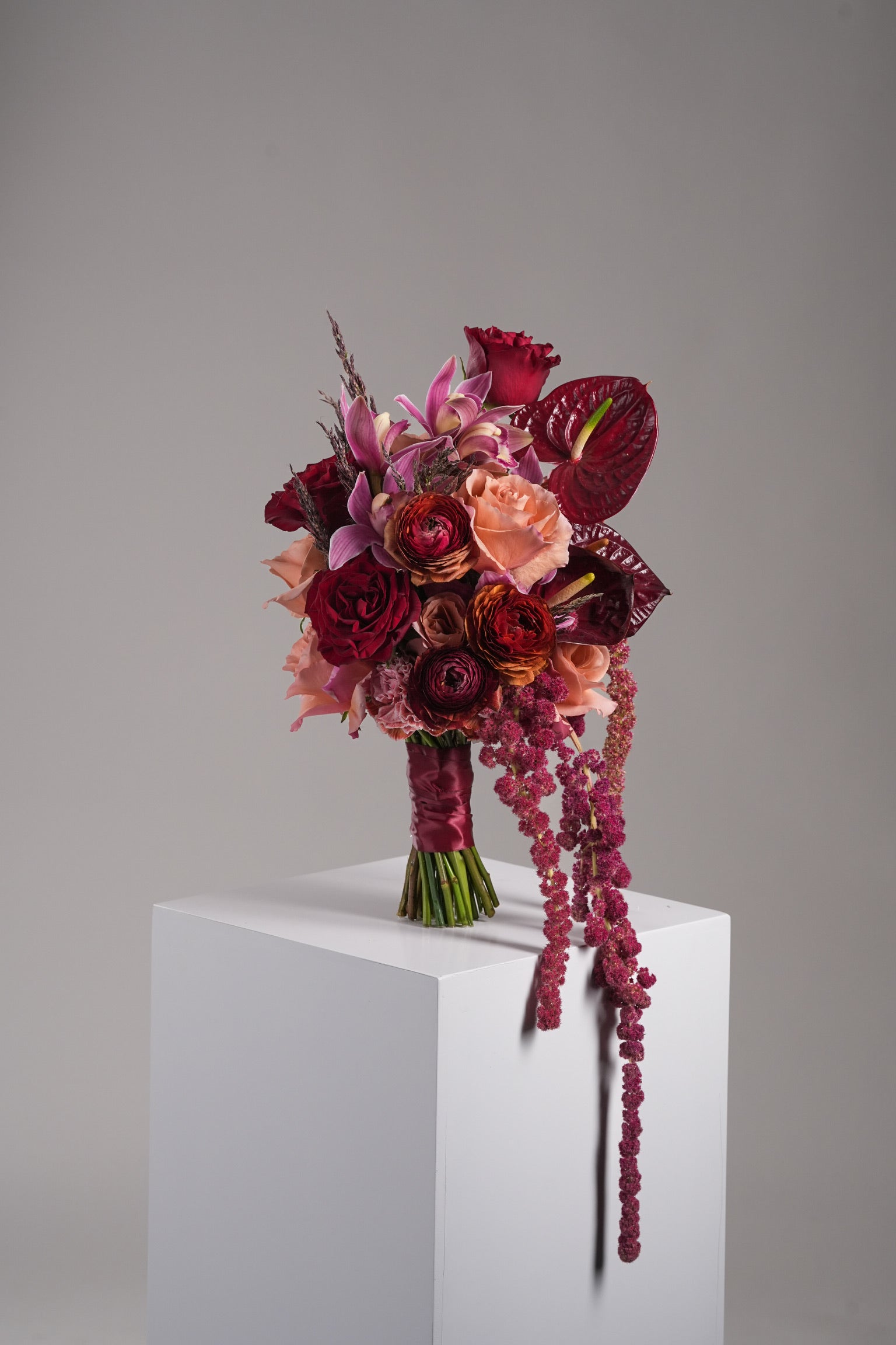 Just Bloom HK Gloria bridal bouquet front angle with orchids and roses, dark wrap presentation