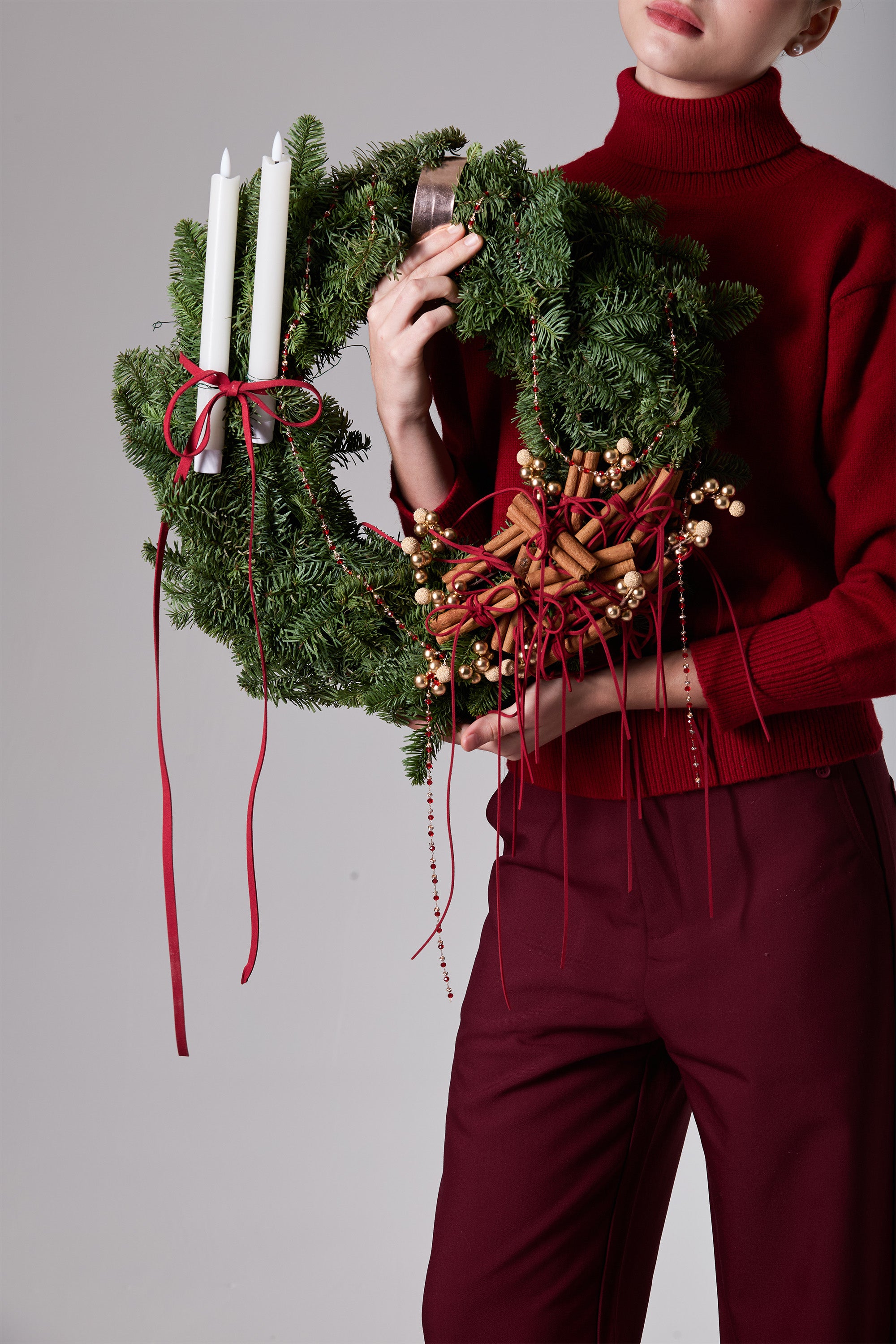 Glowing Emberwheel festive wreath featuring winter evergreens and gold berries