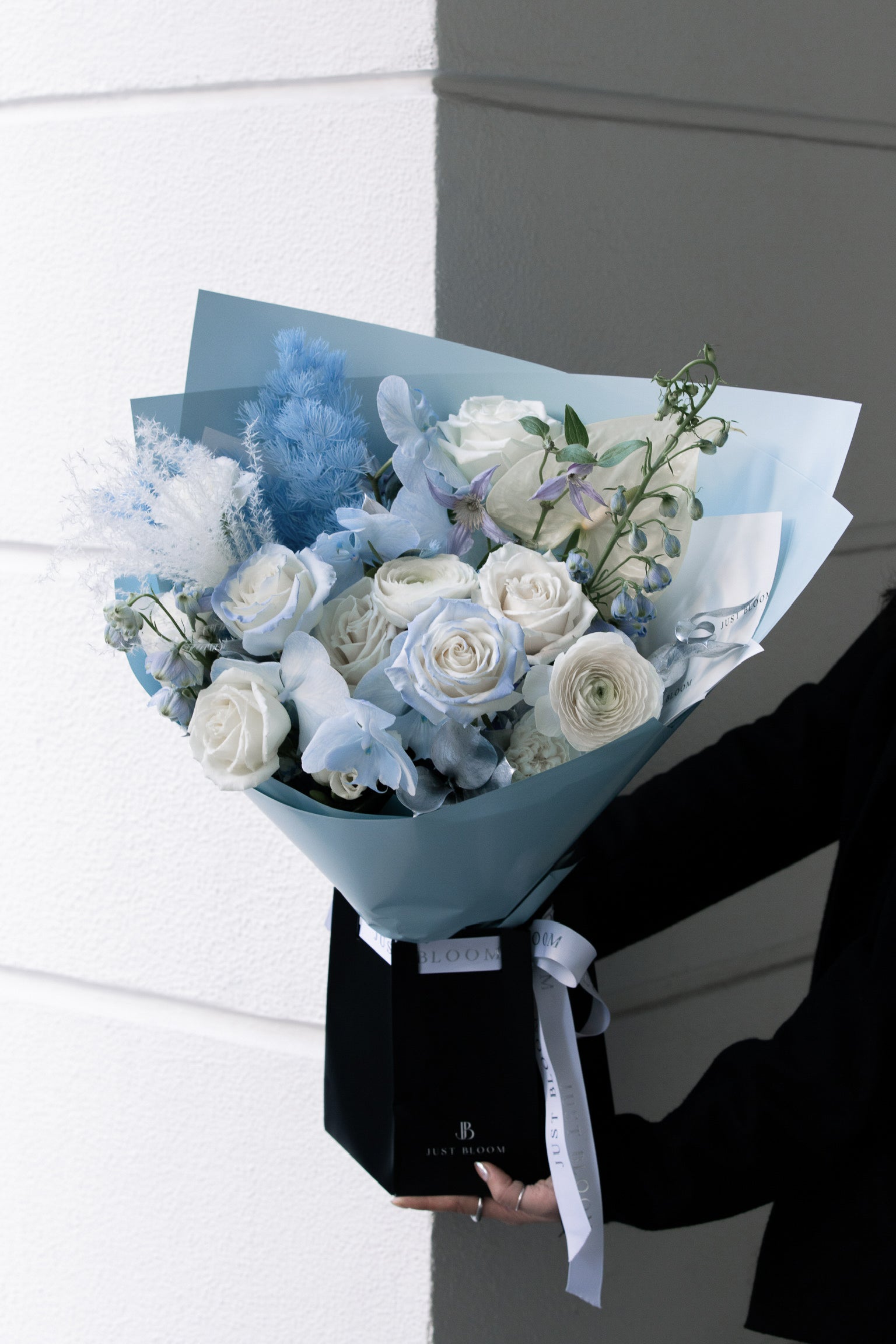 Icebound Bloom white and blue floral arrangement in gift wrap