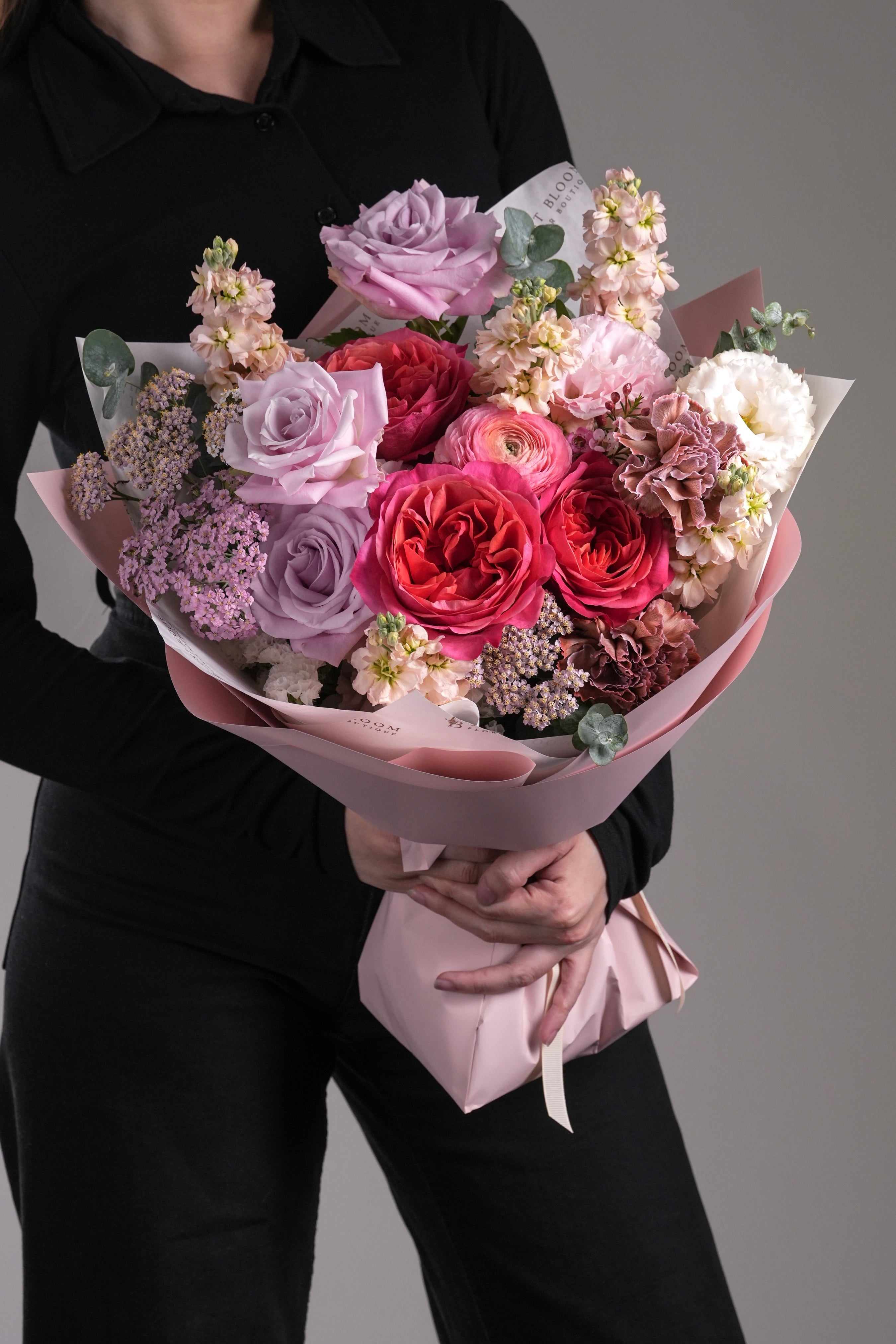 Close-up of Celia flower arrangement featuring Ecuadorian roses, carnations, and ranunculus