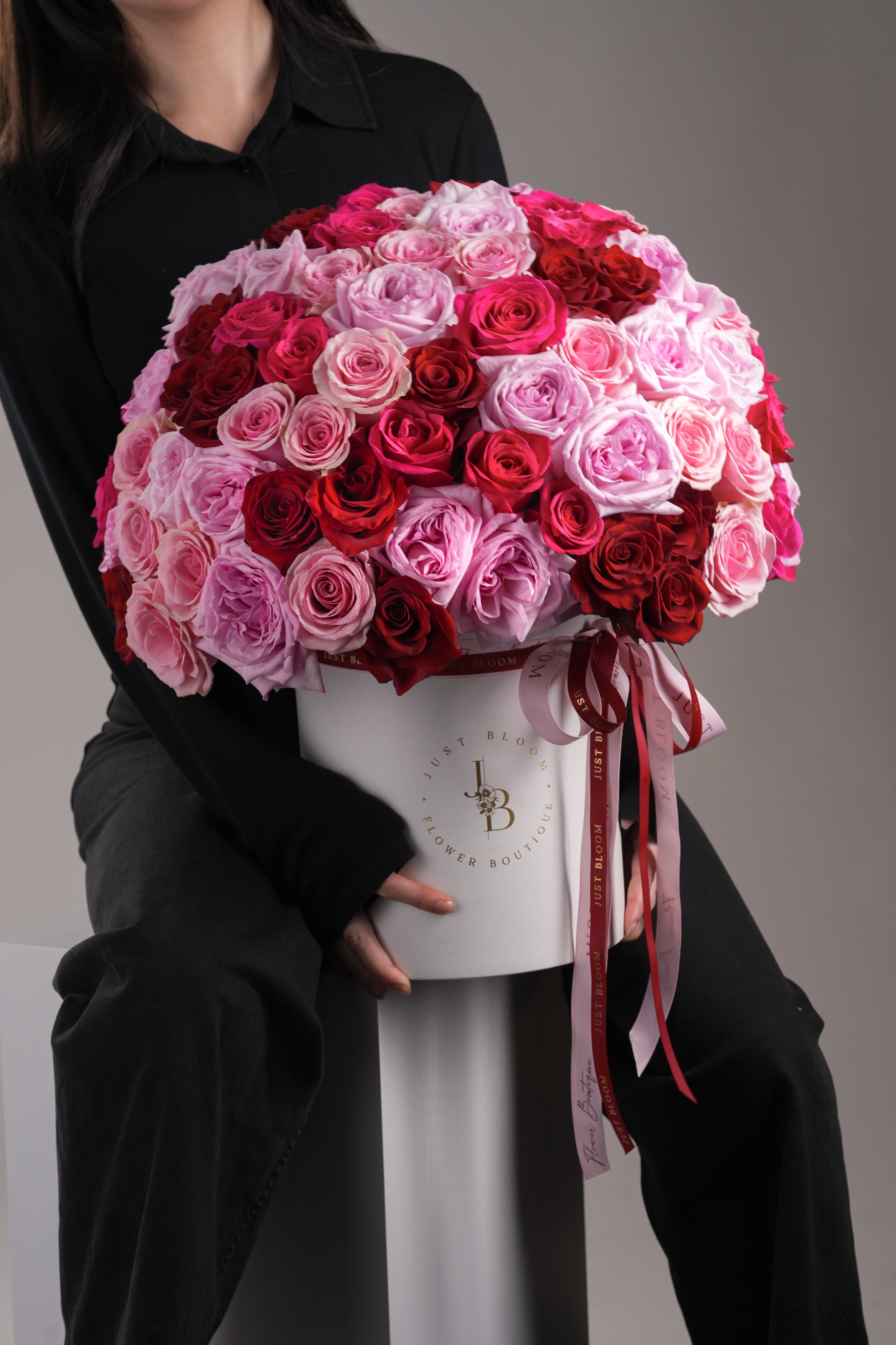 Model holding the Dora flower box, showcasing its lush and colourful rose arrangement