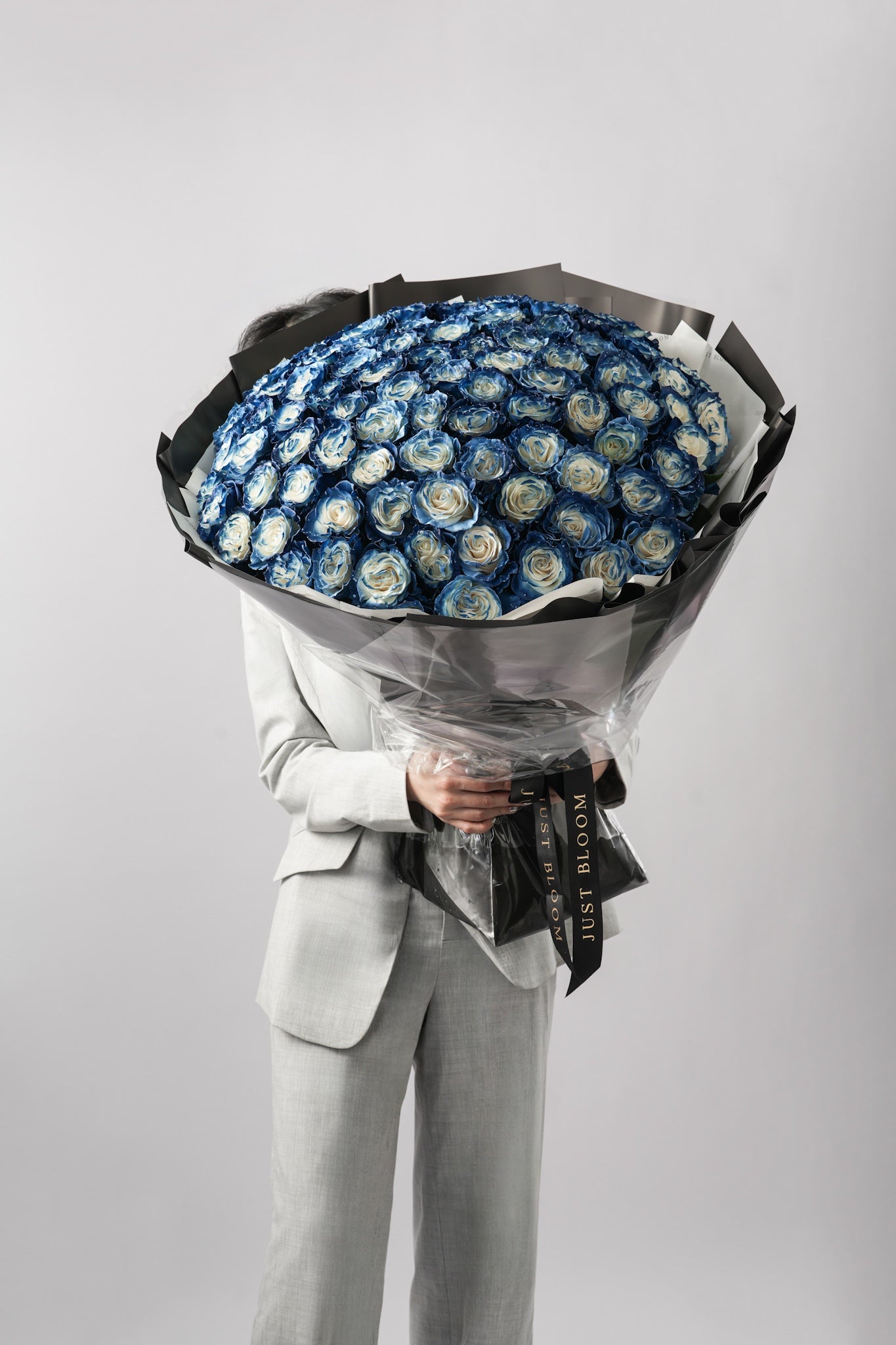 Model holding large ombré blue and ivory rose bouquet from Just Bloom Hong Kong