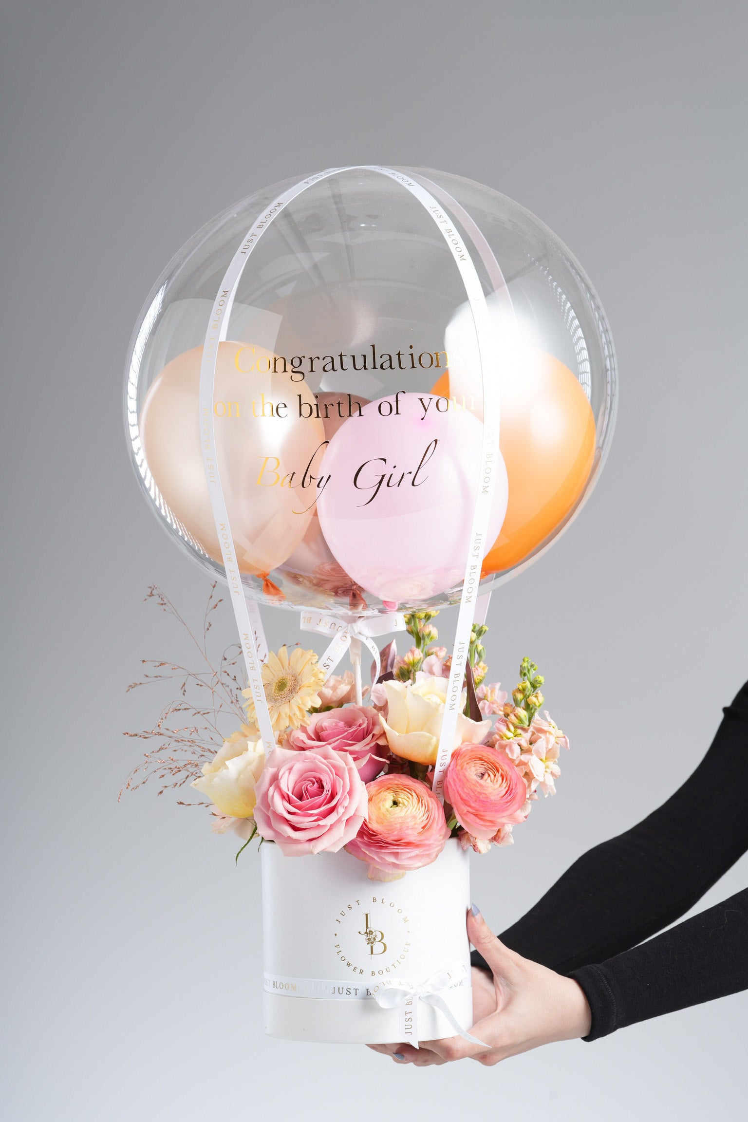 Karsyn - A cheerful floral arrangement with pink roses, peach ranunculus, yellow eustomas, gerberas, snapdragons, and dried accents. Designed to celebrate new beginnings and joyful moments. Available for same-day delivery in Hong Kong by Just Bloom.