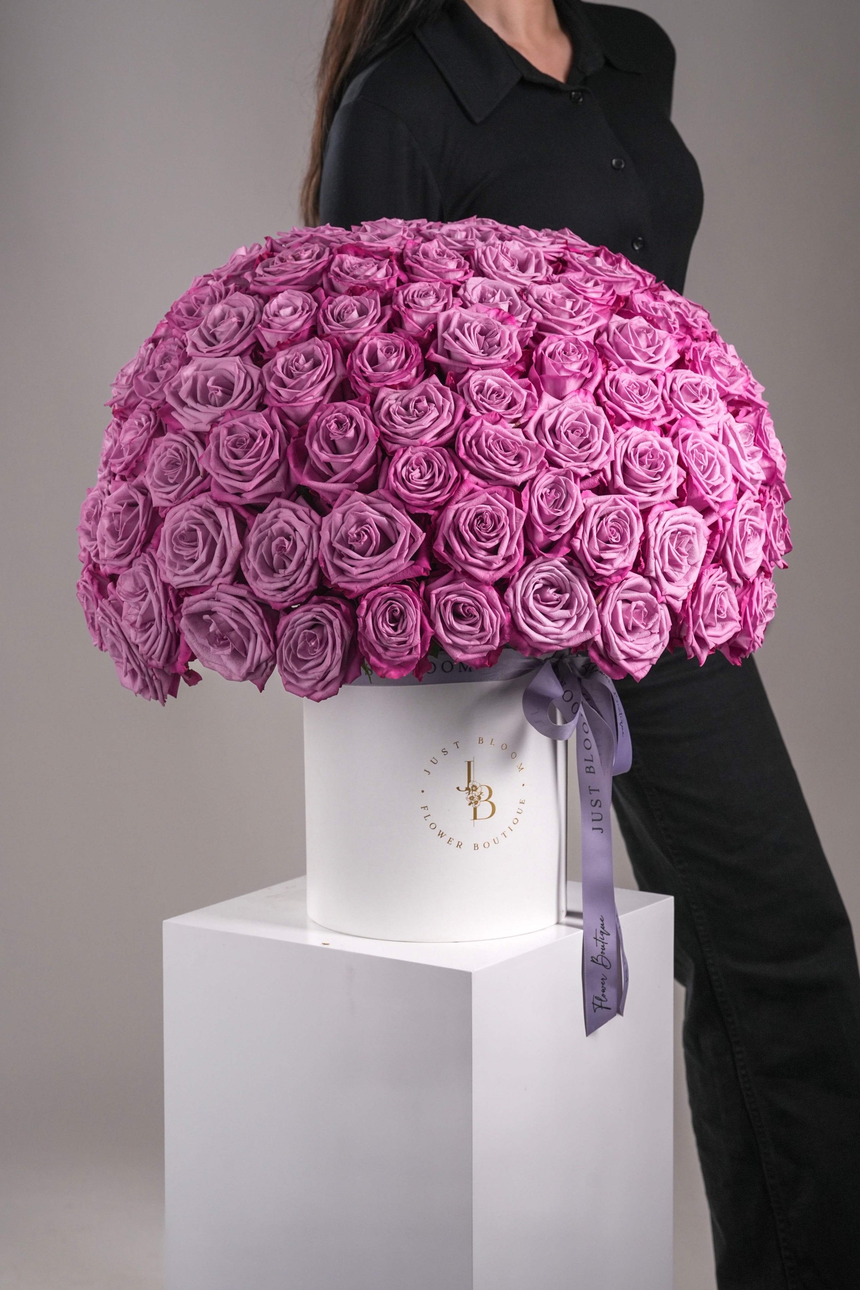 Model holding luxurious purple rose dome arrangement with 99 Ecuadorian roses – Just Bloom Hong Kong