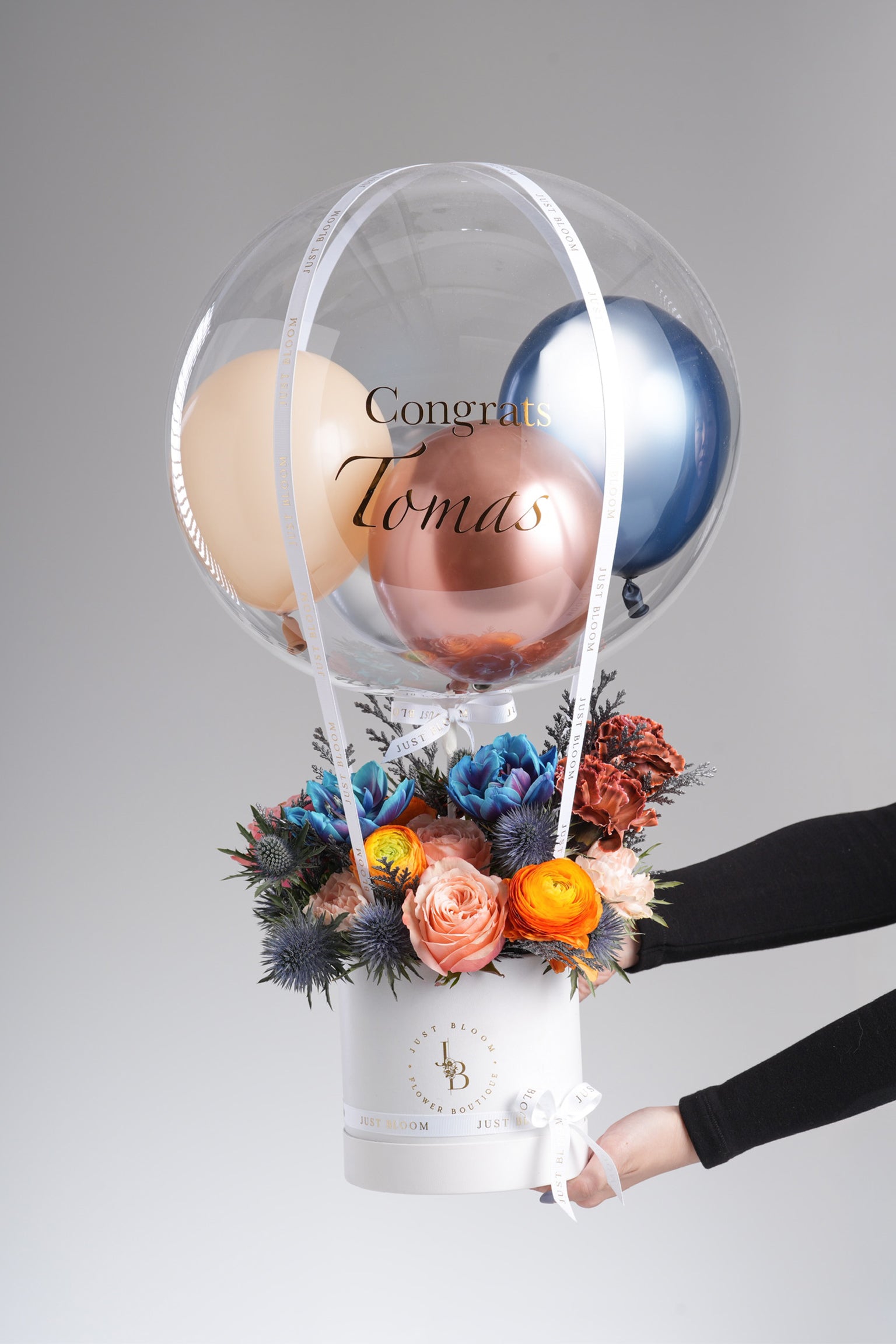 Opal - A bold and modern floral arrangement featuring dyed tulips, peach roses, ranunculus, eryngium, carnations, and rich fillers in vivid blue, orange, and peach tones. Available for same-day delivery in Hong Kong by Just Bloom.