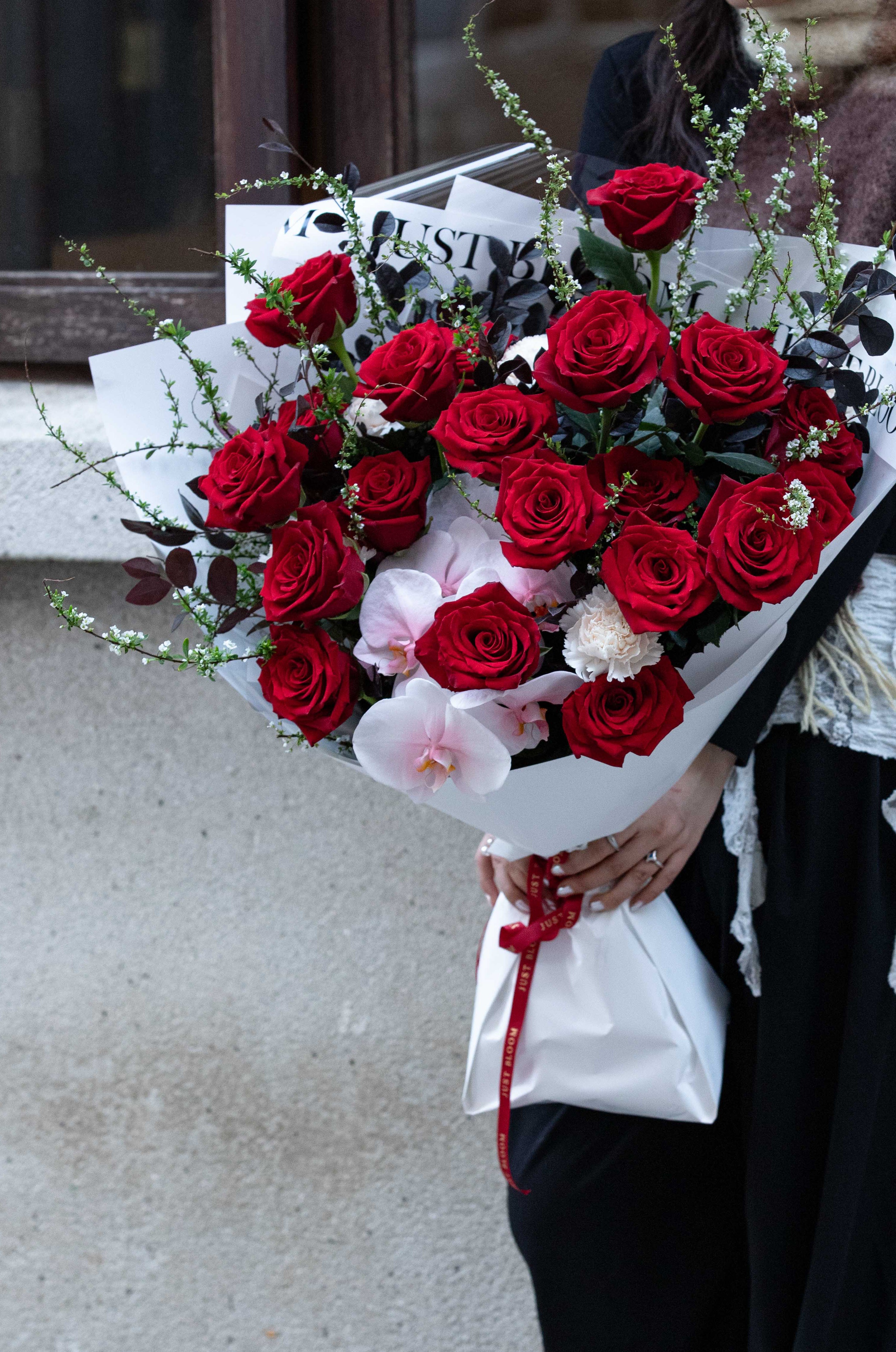 Passionate Bloom fresh flower bouquet with red roses white orchids and architectural branches for Valentine's Day