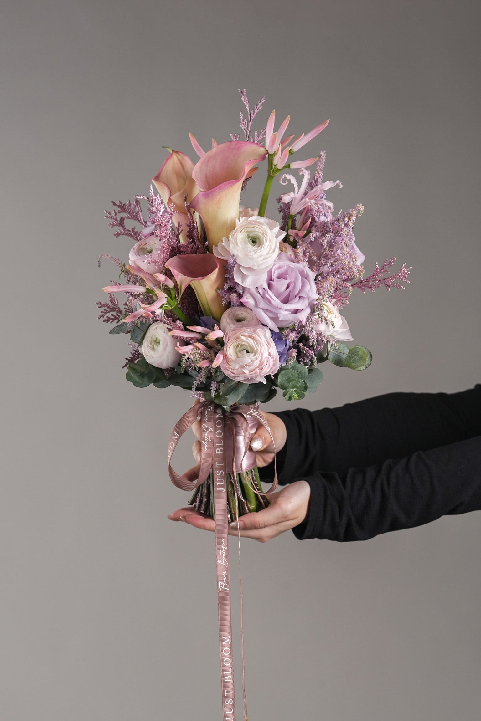 Priscilla bouquet closeup showing pastel pink and purple wedding flowers