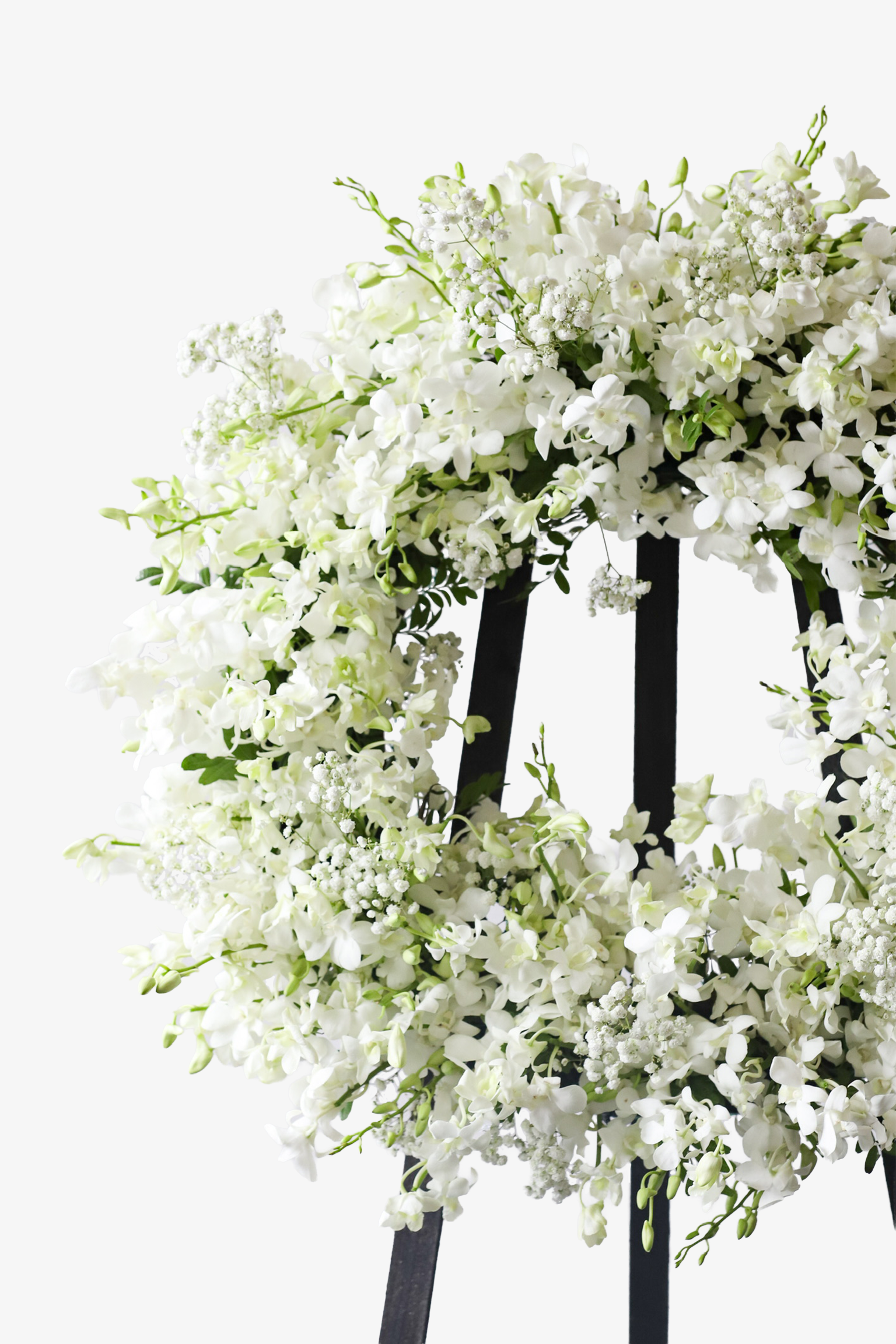 Close-up of the upper section of an all-white condolence wreath showing densely layered white blooms and fine floral fillers on a black stand — Just Bloom Hong Kong
