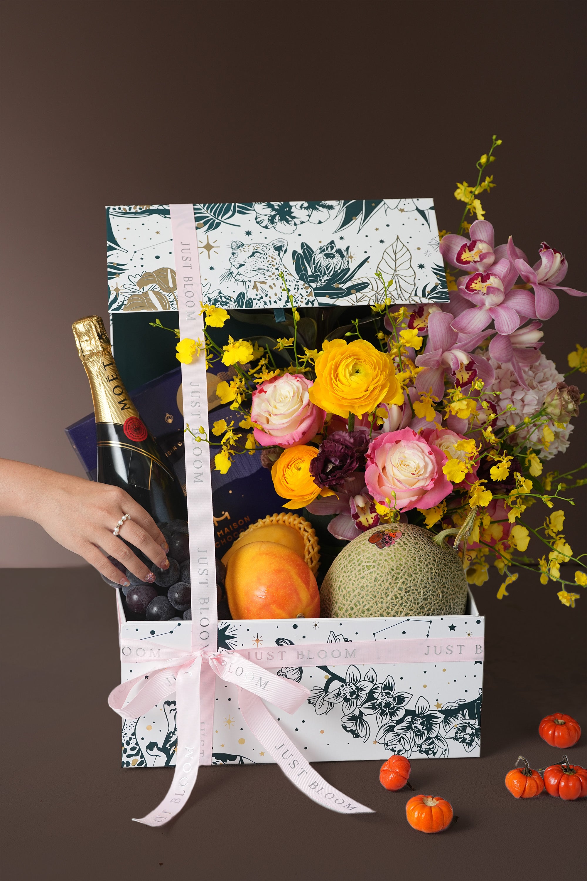 Radiant Harvest gift box detail with orchids, fresh fruits, and seasonal flowers