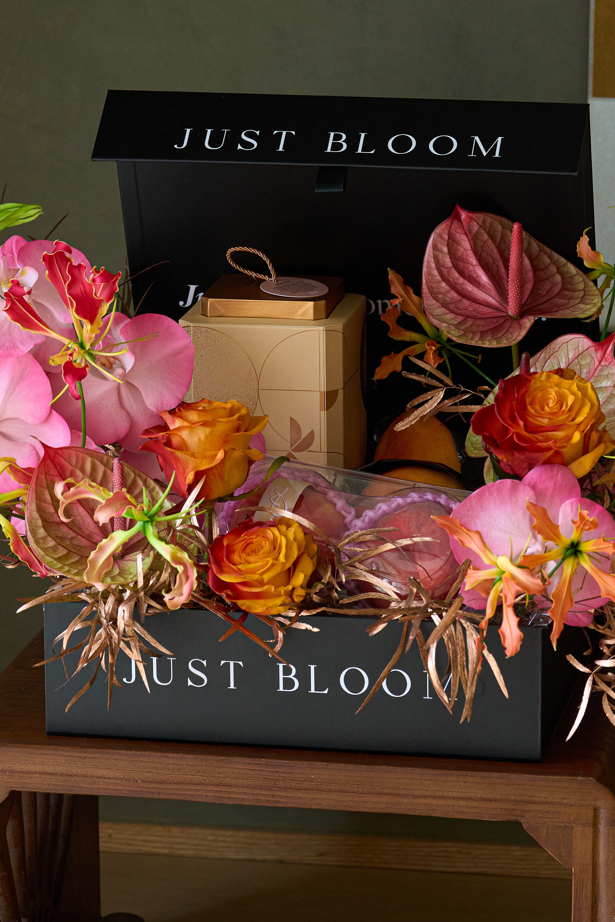 Close-up of Radiant Reunion flower box arrangement with flame lilies, peaches and chocolate gift box — Just Bloom Hong Kong