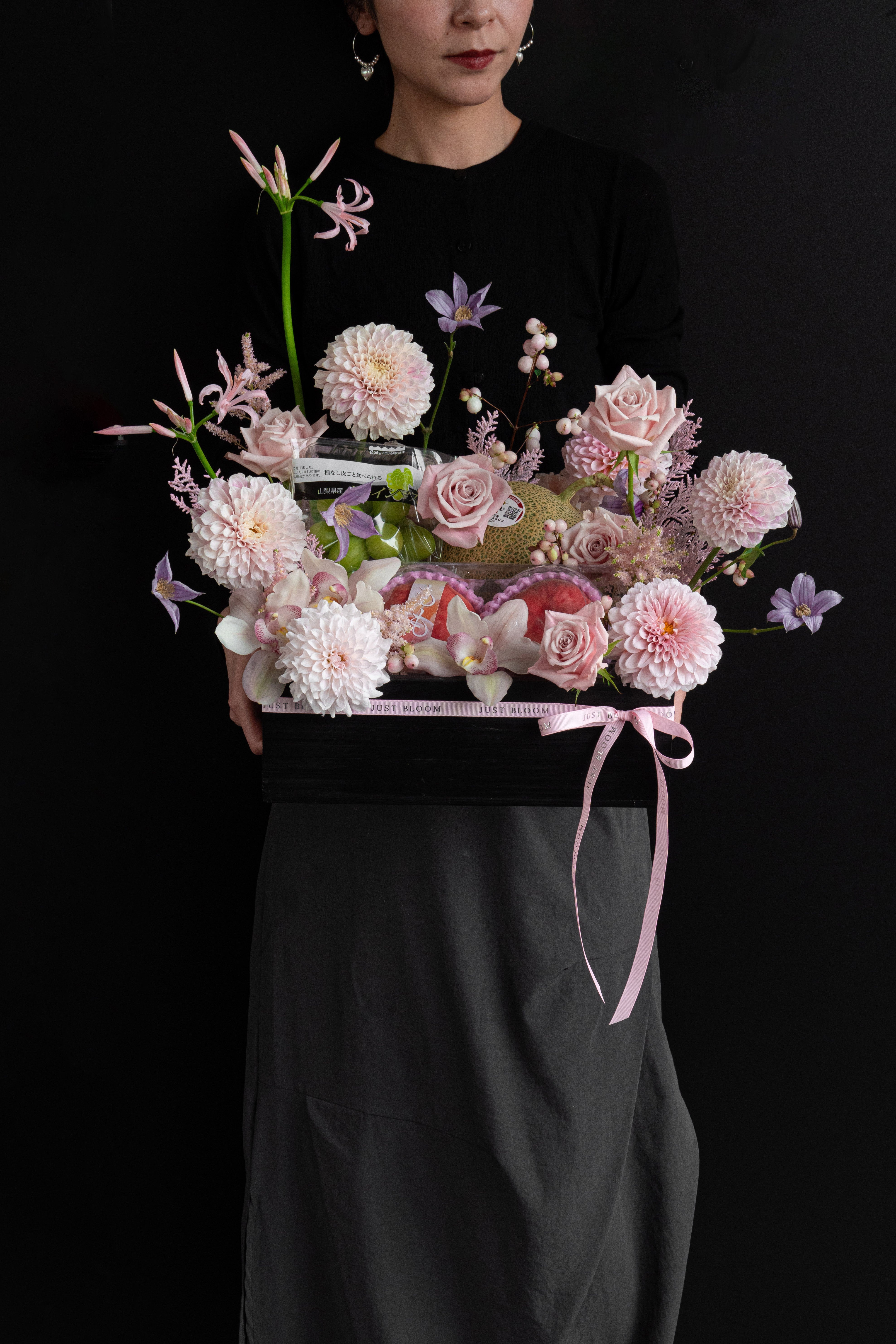 Model holding Just Bloom Rosé Harvest flower box with blush pink florals and Japanese seasonal fruit — Just Bloom Hong Kong