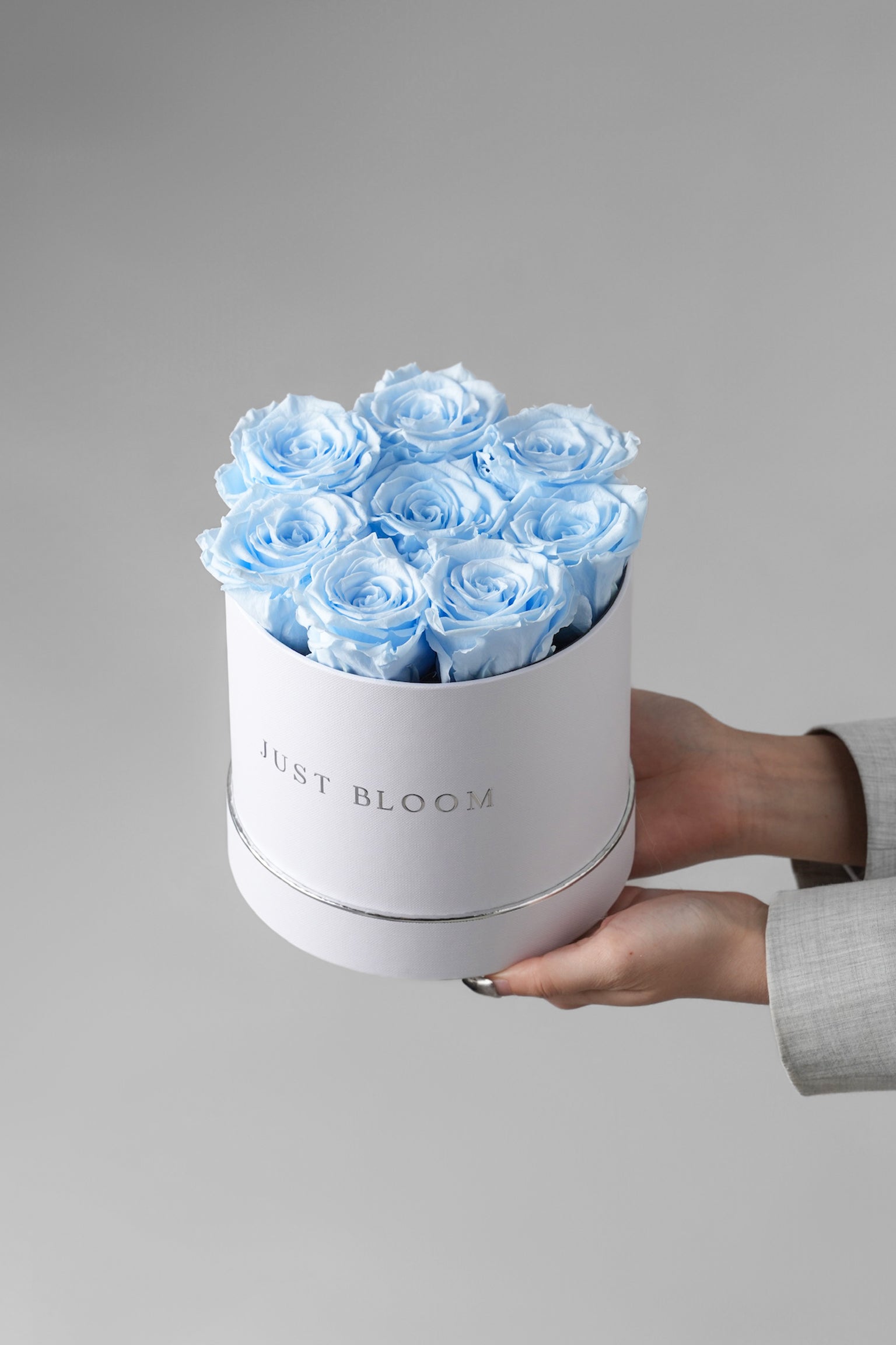 Skyla flower box with preserved baby blue Ecuadorian roses in white round box