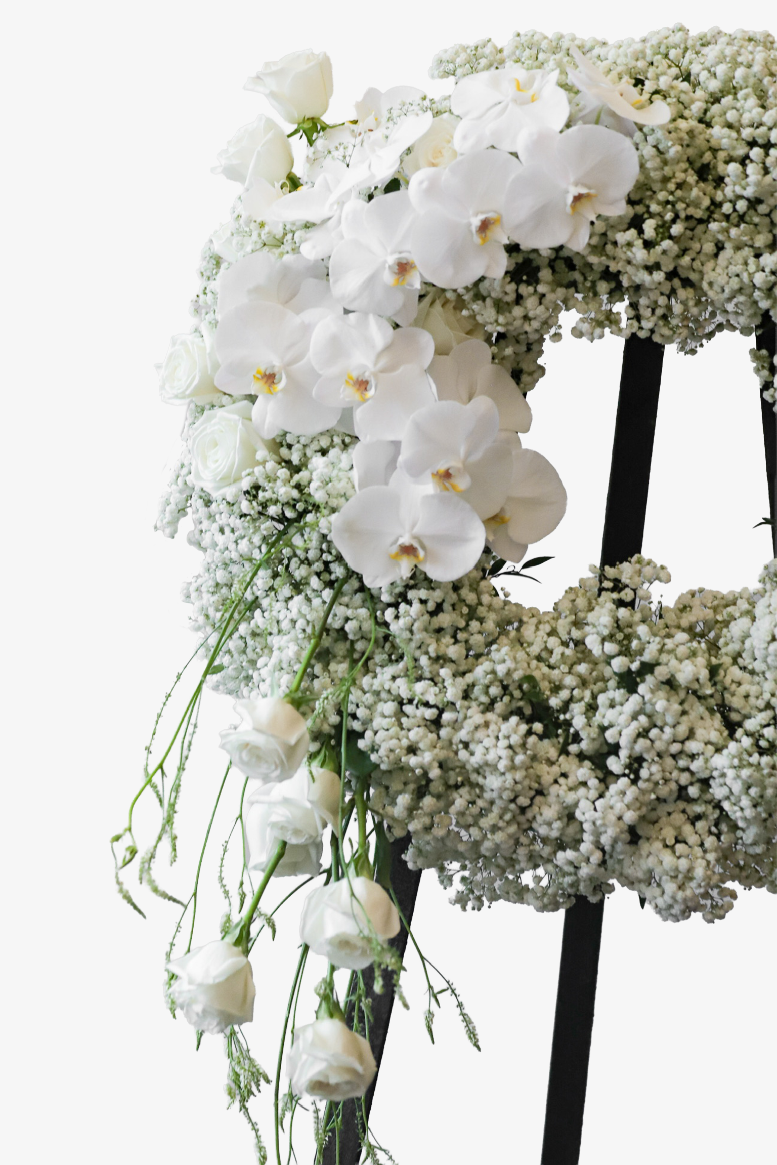 Close-up of the left side of a white condolence wreath showing Phalaenopsis Orchids and a trailing cascade of white Roses and fine greenery against a black stand — Just Bloom Hong Kong