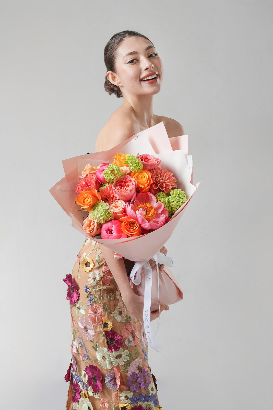 Tender Memory - A cheerful Mother’s Day bouquet featuring coral garden roses, peonies, orange ranunculus, and lime green hydrangeas. A vibrant floral celebration of love from Just Bloom HK.