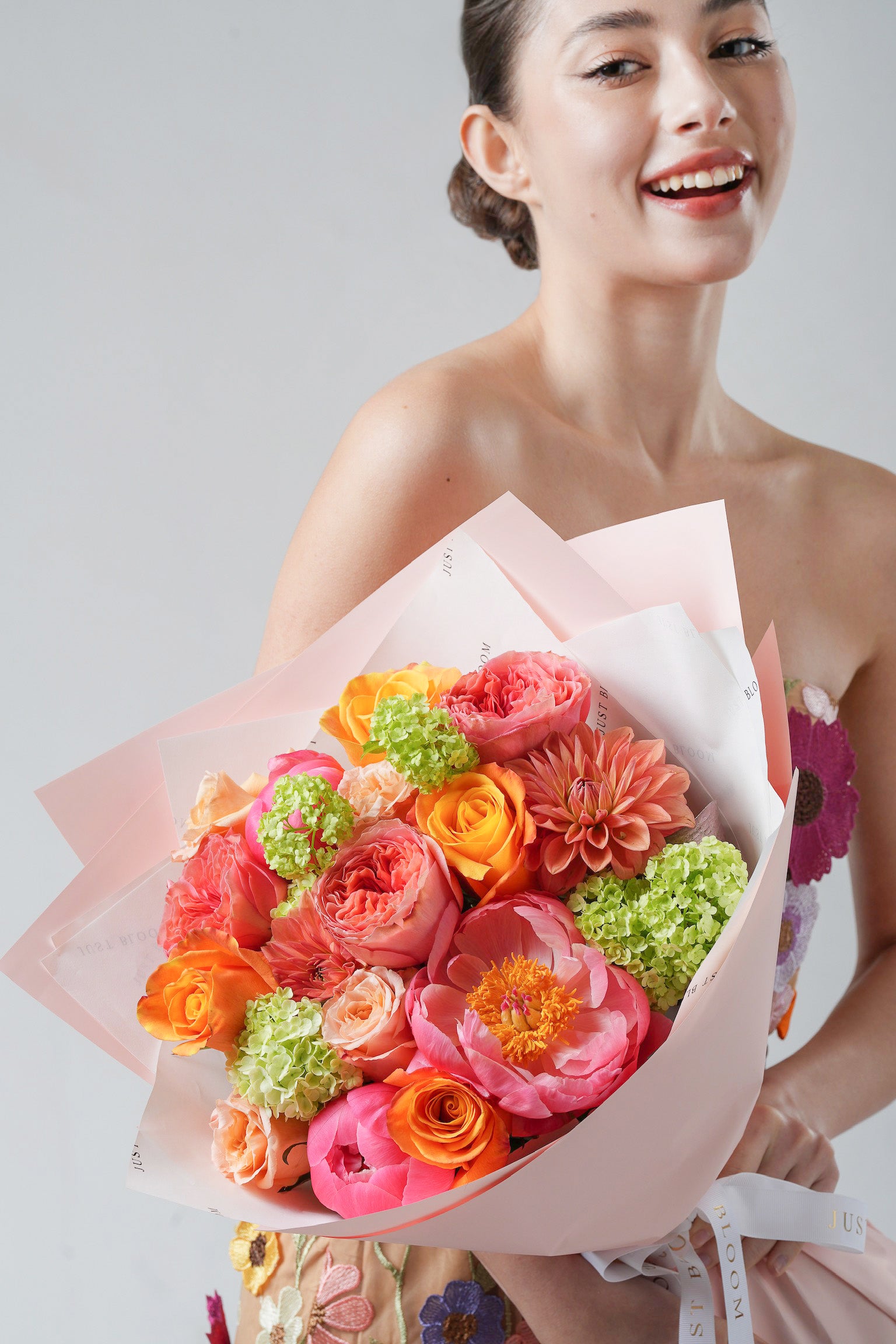Tender Memory - A cheerful Mother’s Day bouquet featuring coral garden roses, peonies, orange ranunculus, and lime green hydrangeas. A vibrant floral celebration of love from Just Bloom HK.