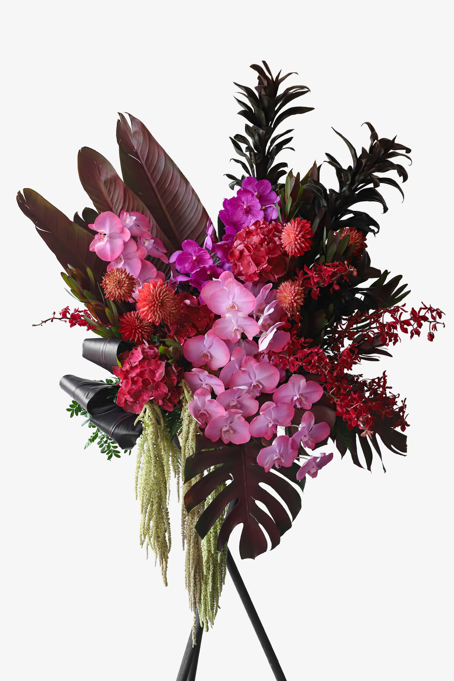 Tropical Fire luxury flower stand by Just Bloom Hong Kong showcasing bold red, pink and magenta blooms with sweeping dark tropical leaves on a tripod stand