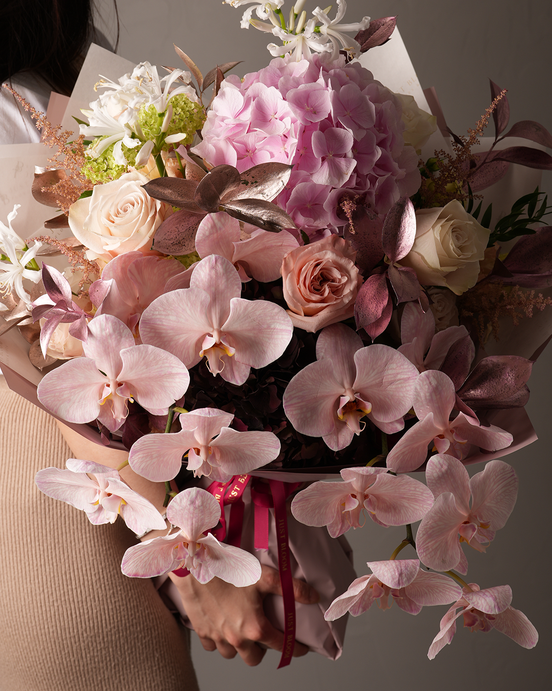 Close-up of Georgia bouquet with blush moth orchids, hydrangeas, and metallic leaves – Just Bloom Hong Kong