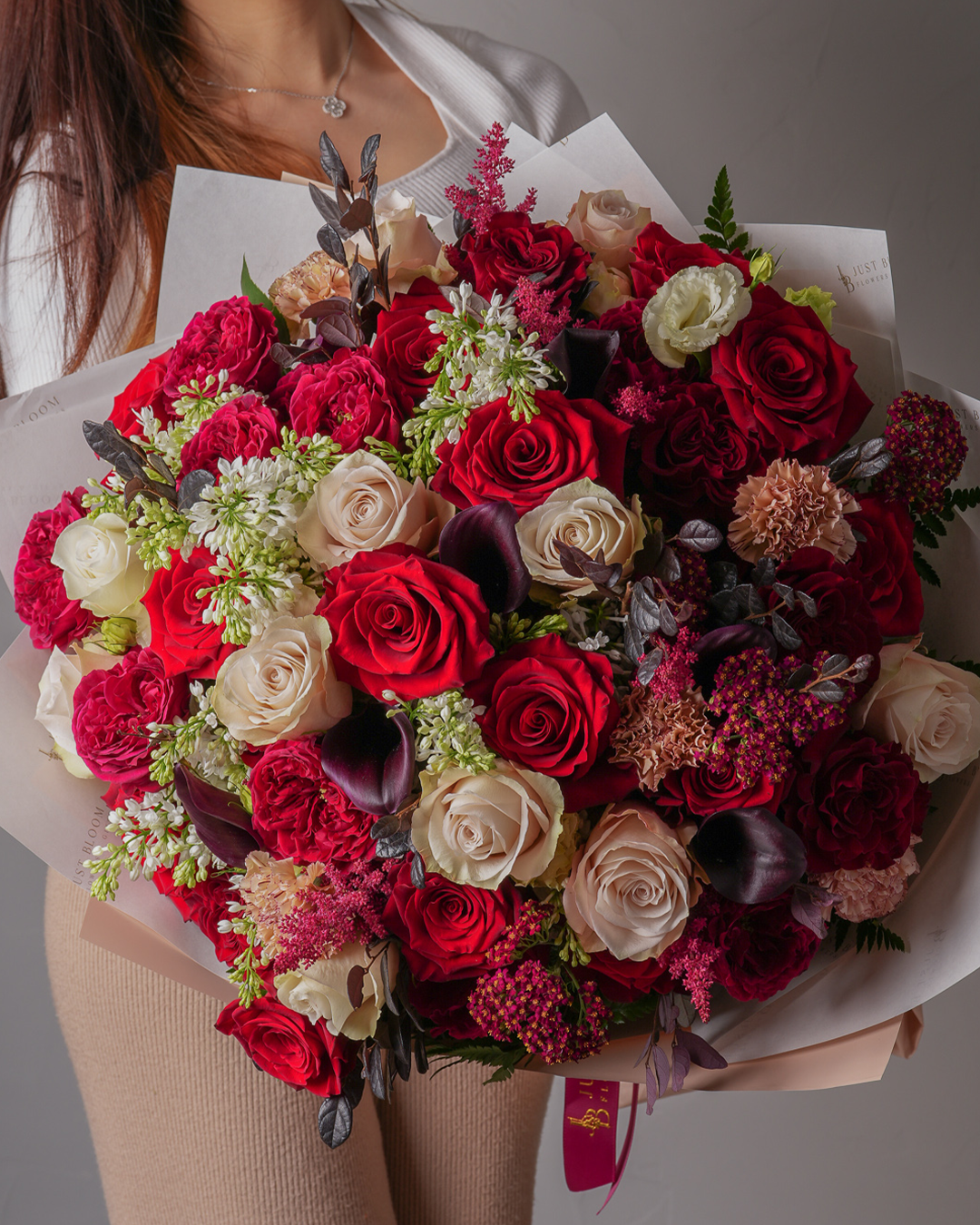 Annabelle bouquet with red and nude roses, garden roses, and deep purple florals – full bouquet view