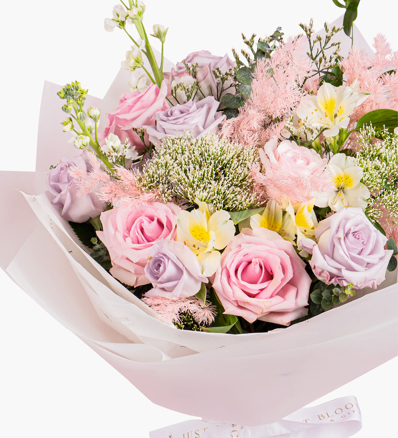 Close-up view of Kisses bouquet showing pink roses, fluffy smoke grass, and yellow daisies