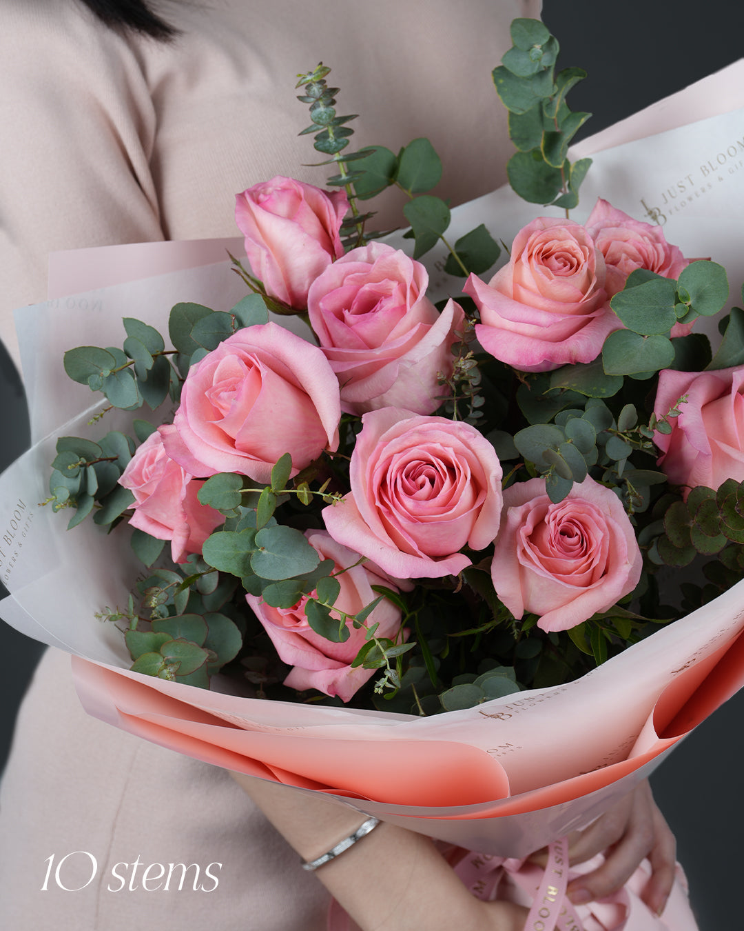 Pink Lemonade close-up showing 10 pink roses and fresh eucalyptus