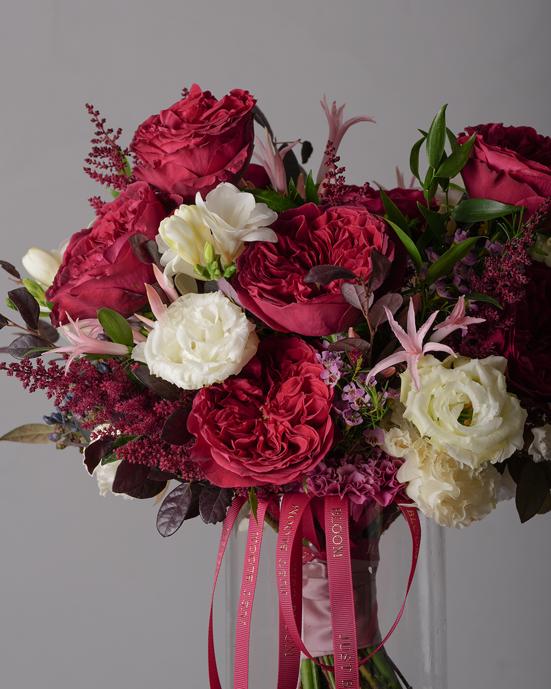 Ruth bridal bouquet close-up with crimson roses and delicate white floral details