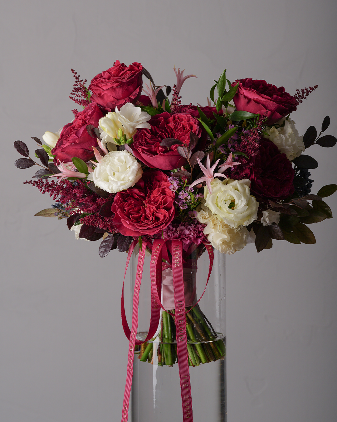 Ruth premium wedding bouquet in a vase with cascading Just Bloom ribbons