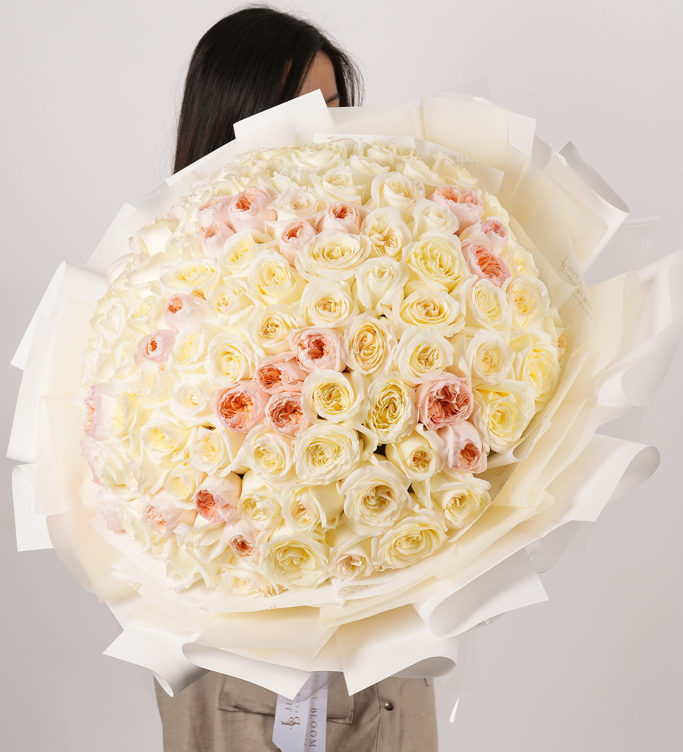 White garden and David Austin Juliet roses bouquet with a total of 99 stems