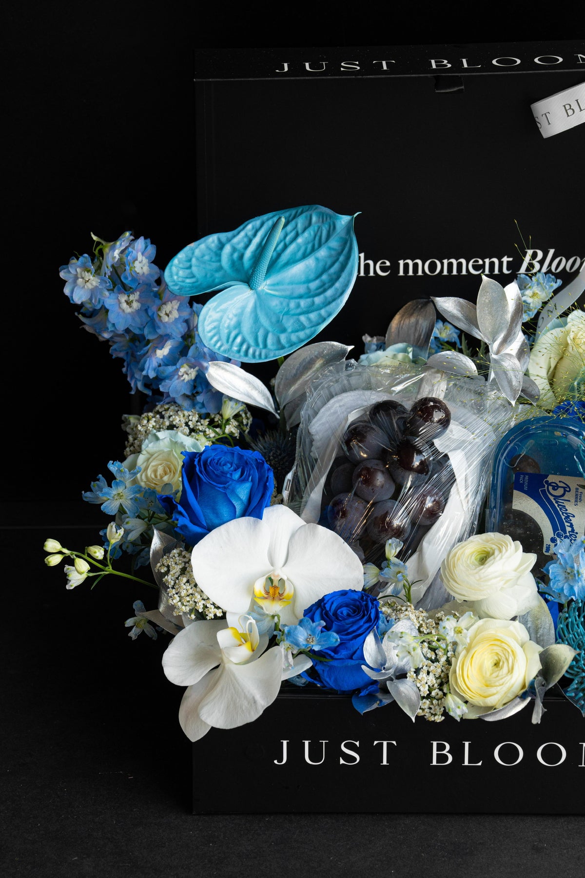Close-up of a luxury all-blue floral hamper with curated premium fruits nestled within an abundant blue floral arrangement — Just Bloom Hong Kong